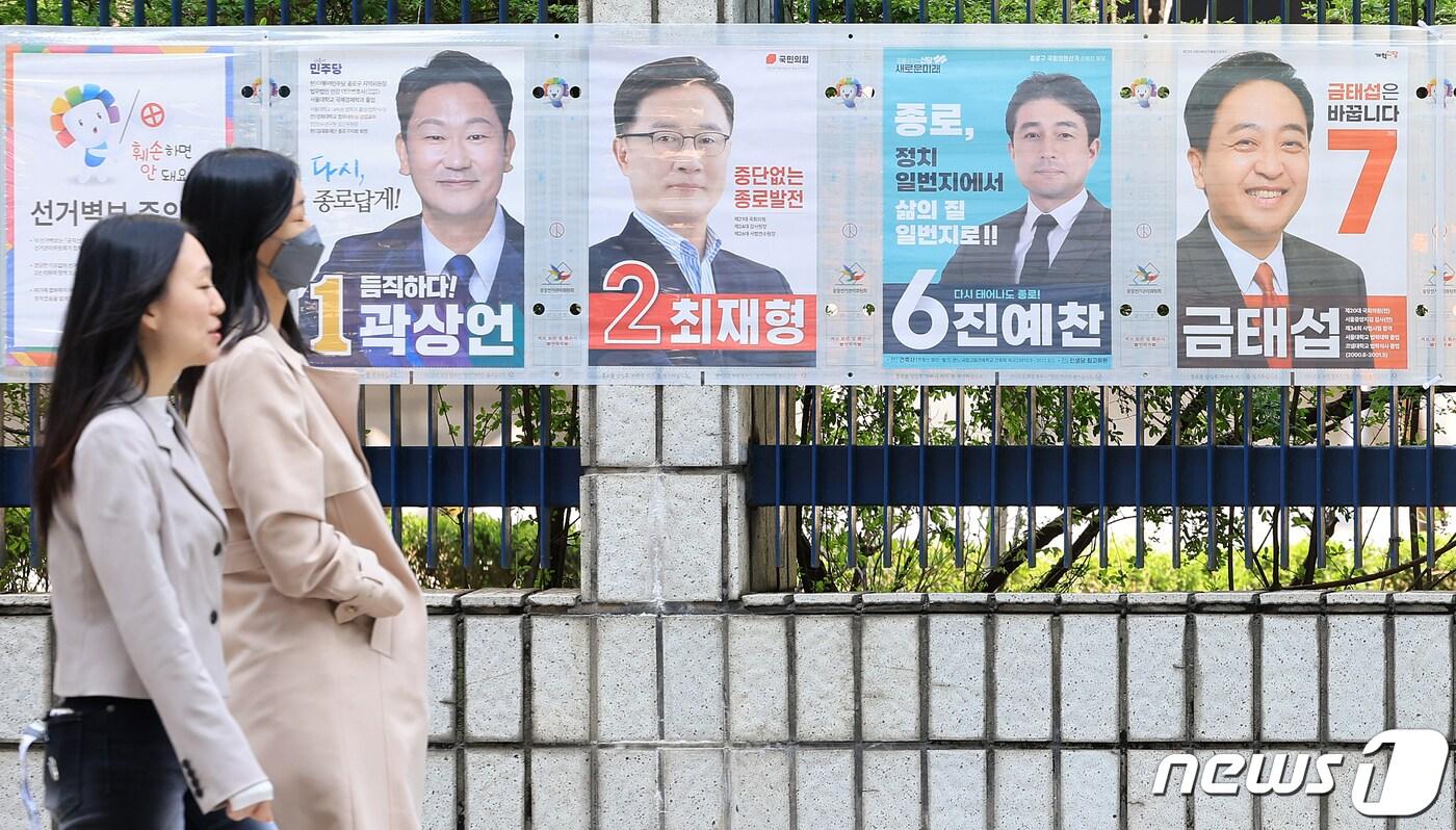 본문 이미지 - 제22대 국회의원 선거를 하루 앞둔 9일 오후 서울 종로구 서울경찰청 앞에서 유권자들이 종로구 후보자들의 선거벽보 앞으로 지나고 있다. 2024.4.9/뉴스1 ⓒ News1 김진환 기자