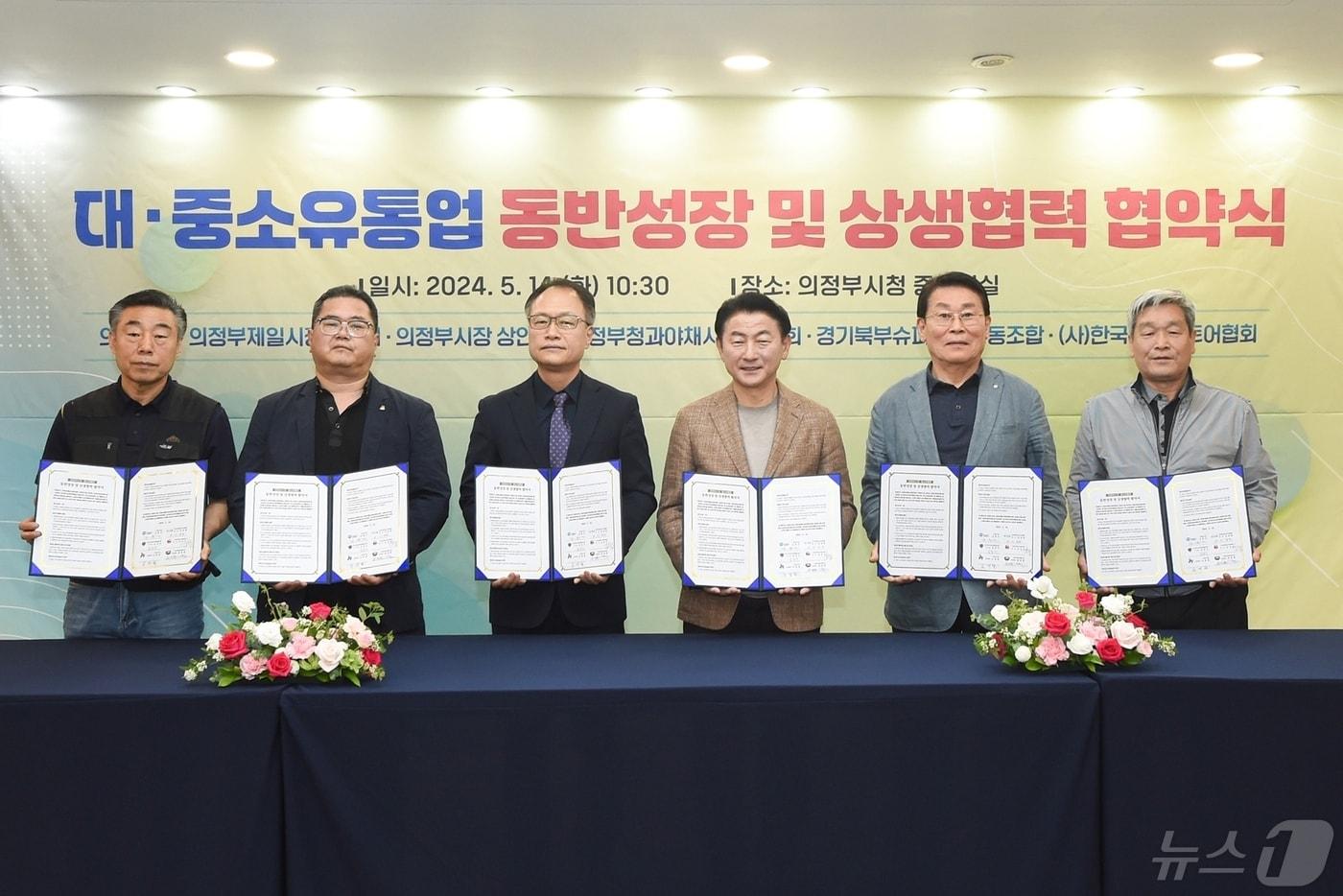 본문 이미지 - 김동근 시장이 5월 14일 시청 중회의실에서 제일시장번영회, 의정부시장상인회, 청과야채시장상인회, 경기북부슈퍼마켓협동조합, (사)한국체인스토어와 ‘대‧중소유통업 동반성장 및 상생협력 협약’을 체결하는 모습.