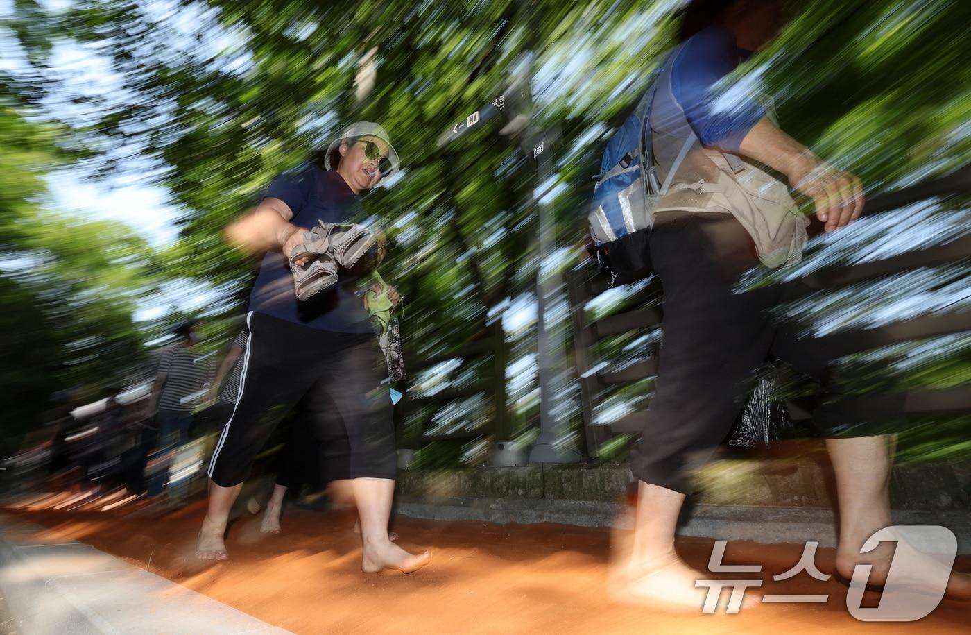 황톳길에서 시민들이 맨발로 산책하고 있다. 뉴스1 자료사진.