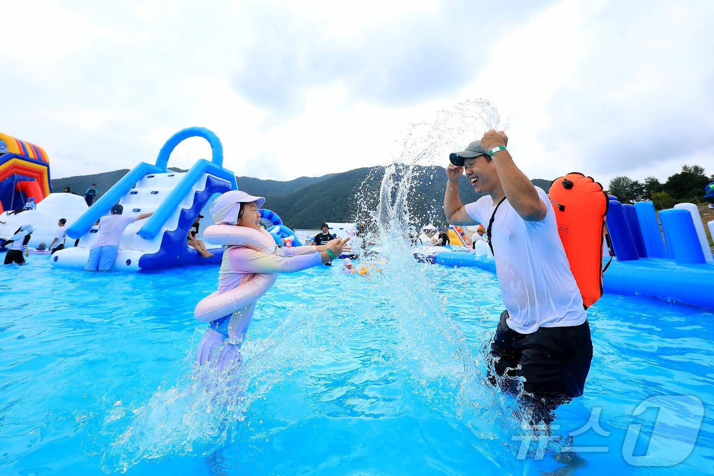 본문 이미지 - 강원 인제군 남면 빙어호에서 열린 '2024 인제 캠프레이크 페스티벌'을 찾은 관광객들이 대형 물놀이장에서 물놀이를 하고 있다. 이번 축제는 오는 23일까지 이어진다.(인제군 제공)/뉴스1