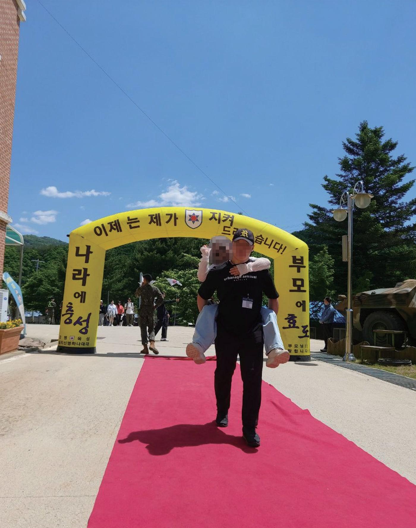 본문 이미지 - 박 훈련병이 입영식 당시 어머니를 업고 있는 모습.(군인권센터 제공)