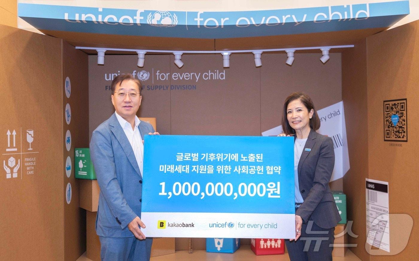 본문 이미지 - 윤호영 카카오뱅크 대표(왼쪽)와 조미진 유니세프 한국위원회 사무총장이 지난 11일 서울 마포구 유니세프 한국위원회에서 진행된 기부금 전달식에 참석해 기념 촬영을 하고 있다.(카카오뱅크 제공)
