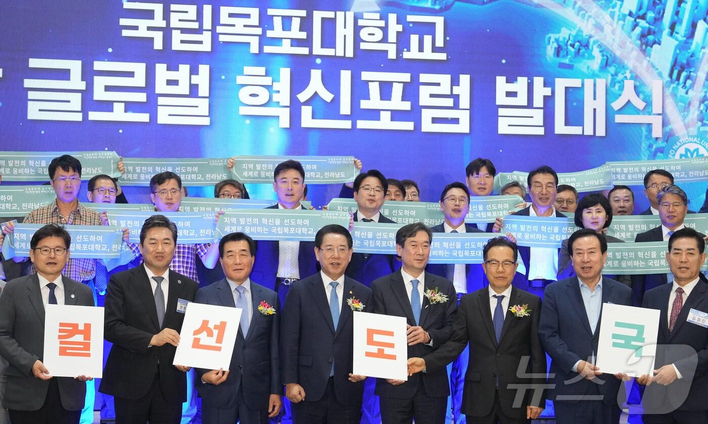 본문 이미지 - 김영록 전라남도지사가 2일 국립목포대 70주년 기념관에서 열린 ‘국립목포대 글로컬 지·산·학연 협력 거버넌스 출범식’에서 송하철 목포대 총장 등 참석자들과 대학-지자체-산업체 간 공동 파트너십 구축과 함께 글로벌 경쟁력을 갖춘 지역 우수 인재 양성 및 동반성장을 위한 퍼포먼스를 하고 있다.(전남도 제공) 2024.7.2/뉴스1