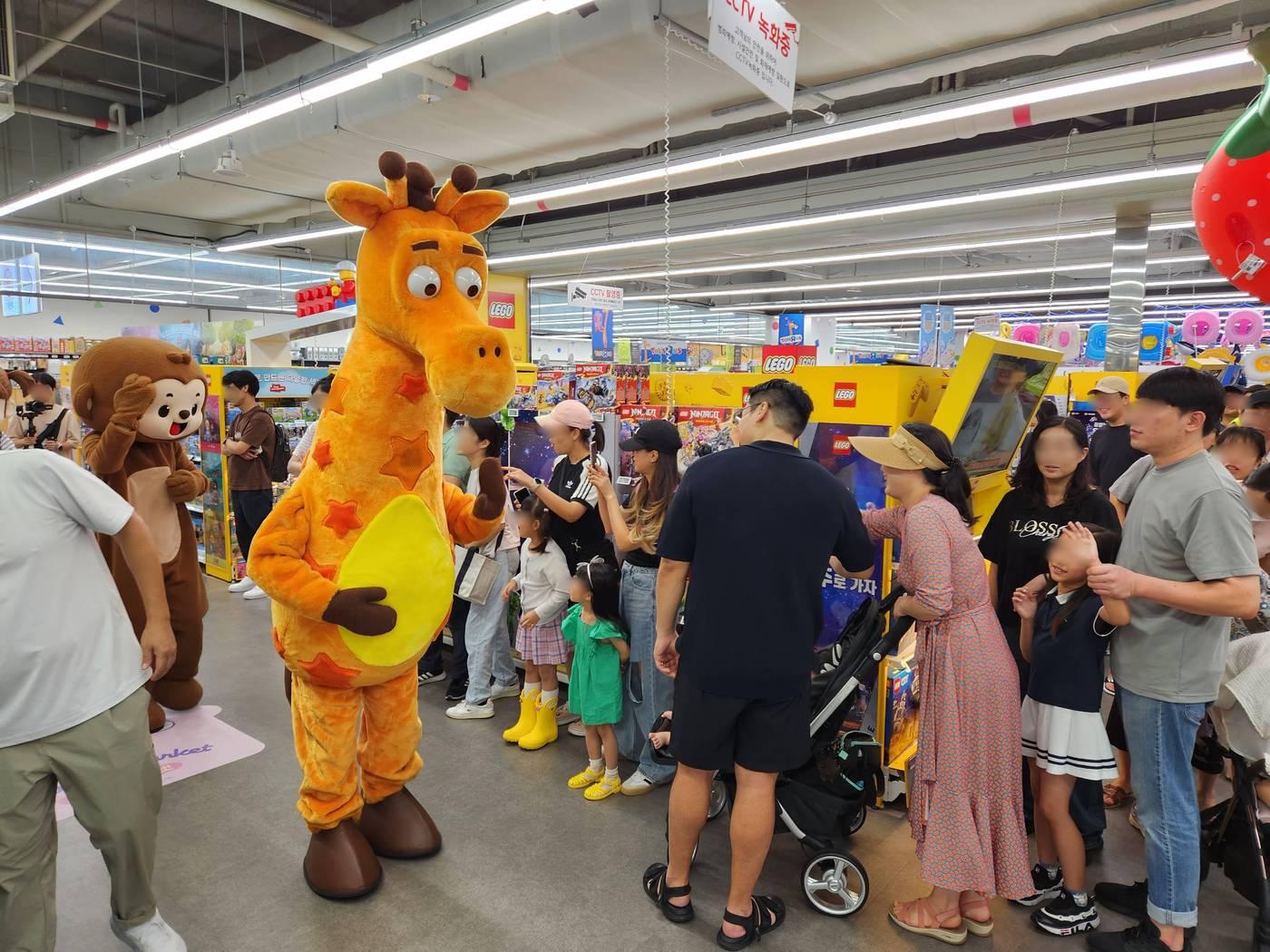 본문 이미지 - 롯데마트 토이저러스 서울 청량리점에서 20일 진행한 플레이 데이 현장 이벤트에서 토이저러스 캐릭터 '제프리'가 고객들과 인사하고 있다(롯데쇼핑 제공).