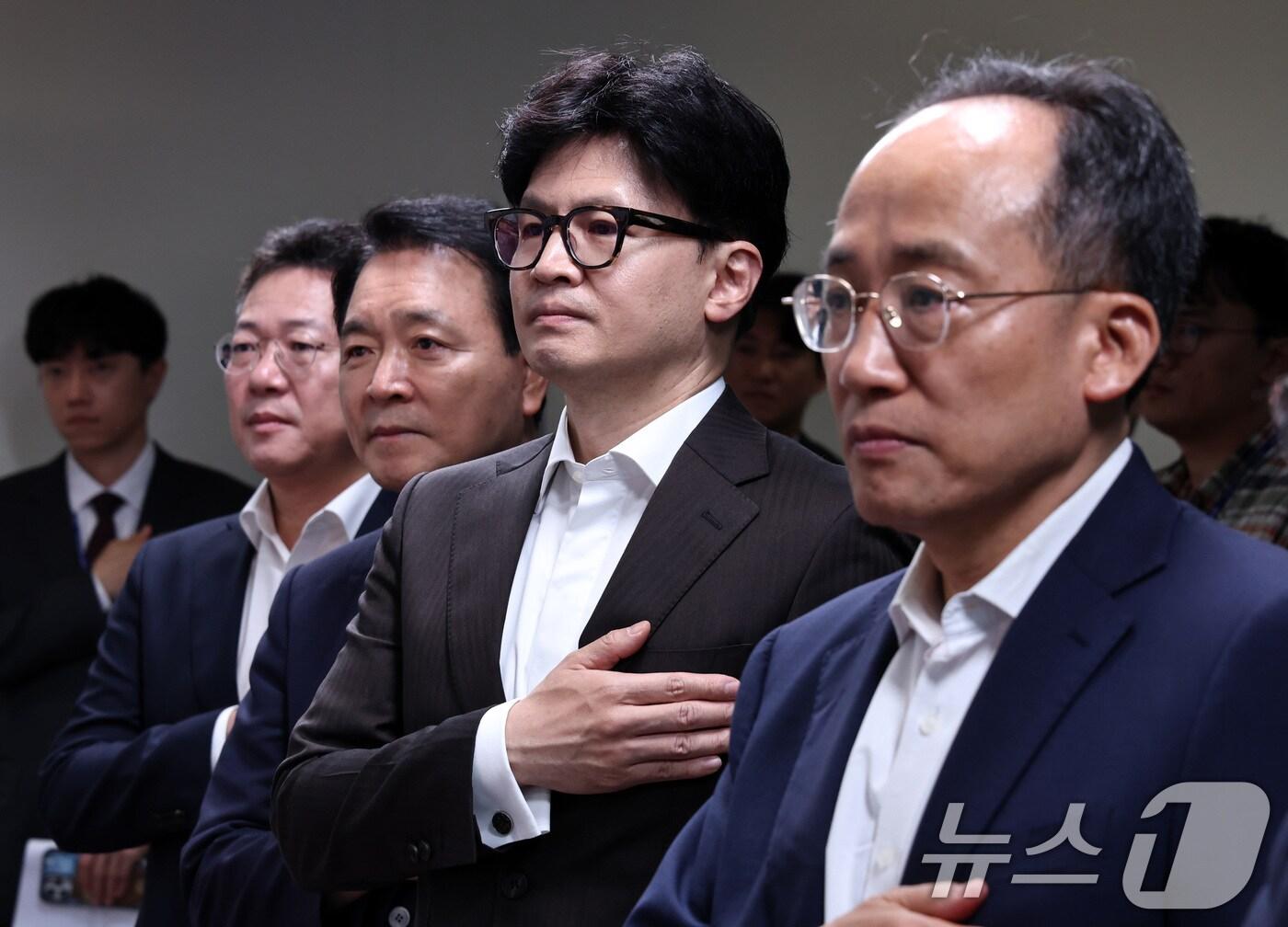 본문 이미지 - 한동훈 대표와 추경호 원내대표를 비롯한 국민의힘 지도부가 26일 오전 서울 여의도 중앙당사에서 열린 사무처당직자 월례조회에서 국기에 대한 경례를 하고 있다. 2024.7.26/뉴스1 ⓒ News1 구윤성 기자