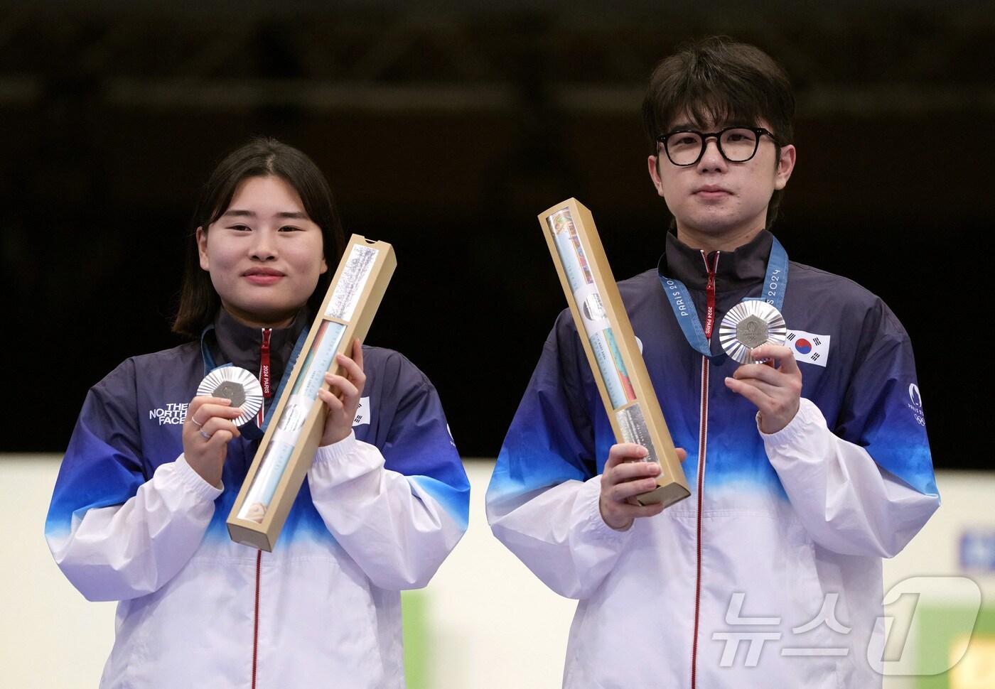 본문 이미지 - 금지현·박하준(오른쪽)이 27일(현지시간) 프랑스 샤토루 슈팅 센터에서 열린 2024 파리올림픽 사격 공기소총 10m 혼성 단체 시상식에서 은메달을 목에 걸고 기념촬영을 하고 있다. 2024.7.27 ⓒ 로이터=뉴스1