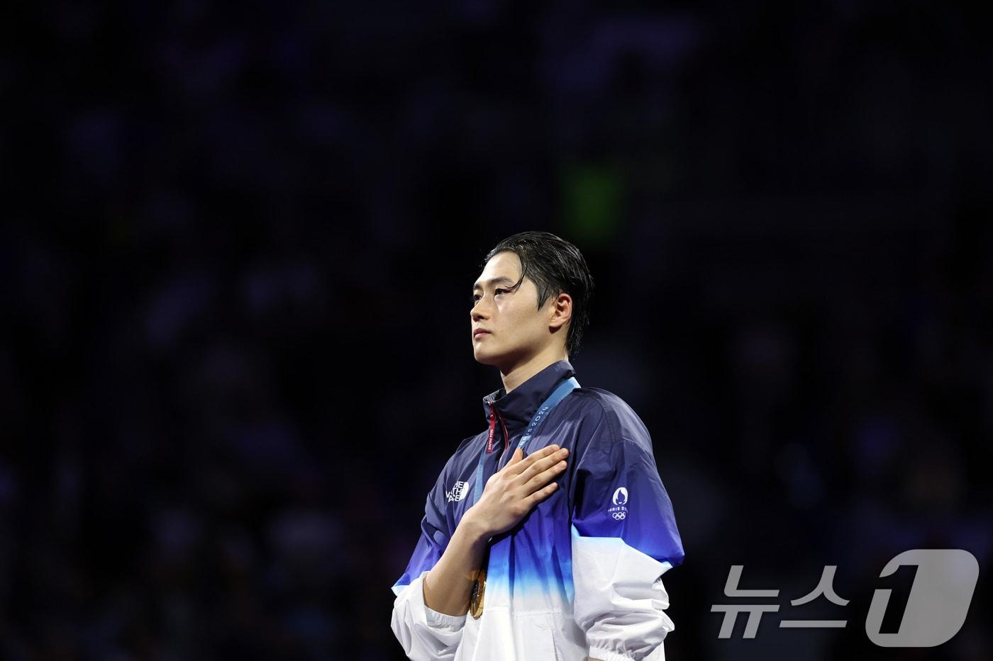 대한민국 펜싱 대표팀 오상욱 선수가 28일(한국시간) 프랑스 파리 그랑 팔레에서 열린 2024 파리올림픽 남자 사브르 개인 결승 시상식에서 금메달을 목에 걸고 애국가에 맞춰 국민의례를 하고 있다. 2024.7.28/뉴스1 ⓒ News1 박정호 기자