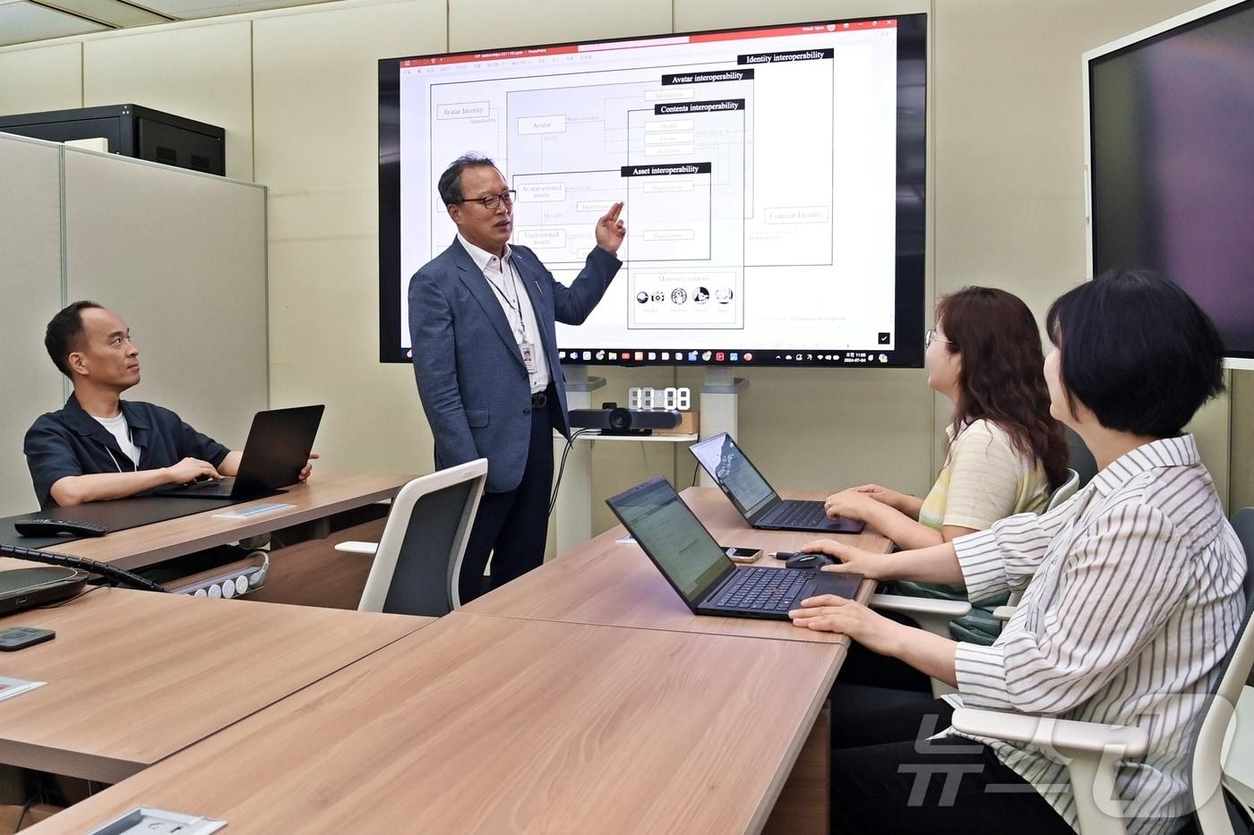 본문 이미지 - 전자통신연 연구진이 메타버스 국제표준 관련 회의를 하고 있다.(ETRI 제공)/뉴스1