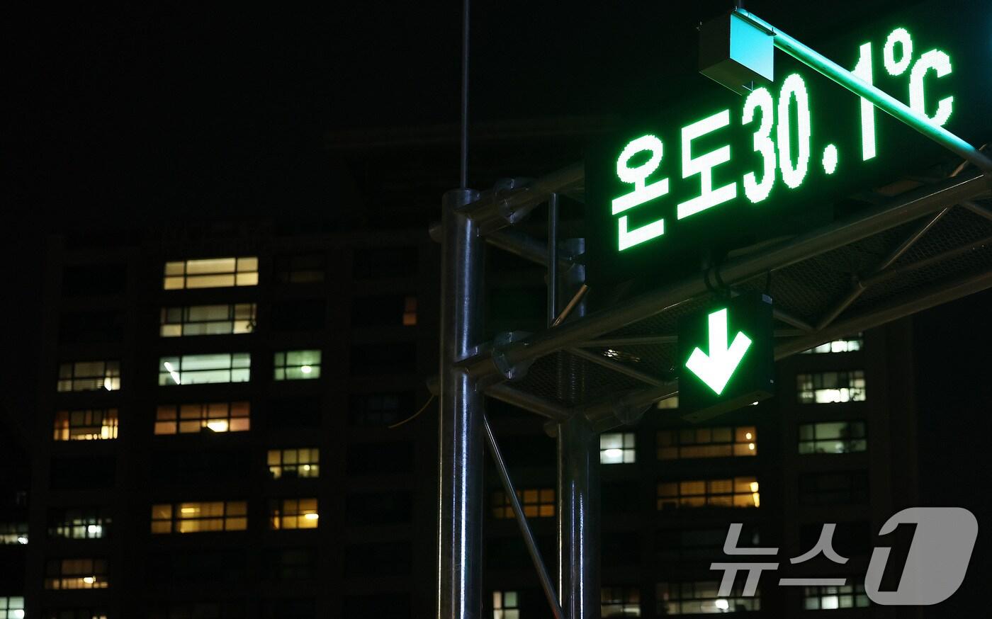 본문 이미지 - 19일 밤 서울 서초구의 한 전광판에 현재 온도가 표시되고 있다. 전광판 뒤로는 아파트 불빛이 보이고 있다. 이날 서울의 열대야는 29일째 이어져 관측 이래 최장 기록을 또다시 경신했다. 2024.8.19/뉴스1 ⓒ News1 박지혜 기자