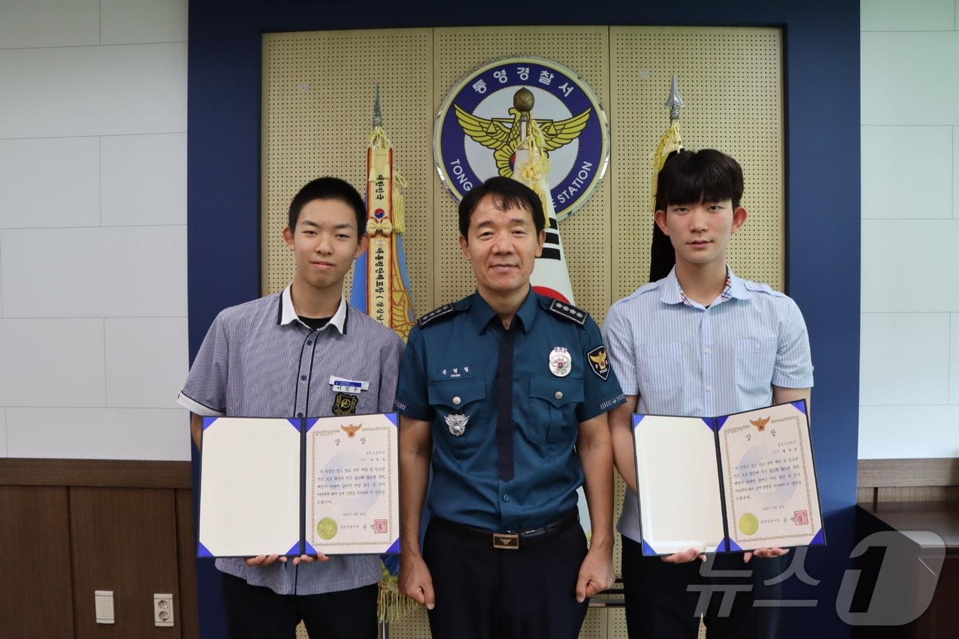 본문 이미지 - 동원고 이진우, 통영고 박지한 학생이 통영경찰서장으로부터 상장을 전달받고 있다.(통영경찰서 제공)