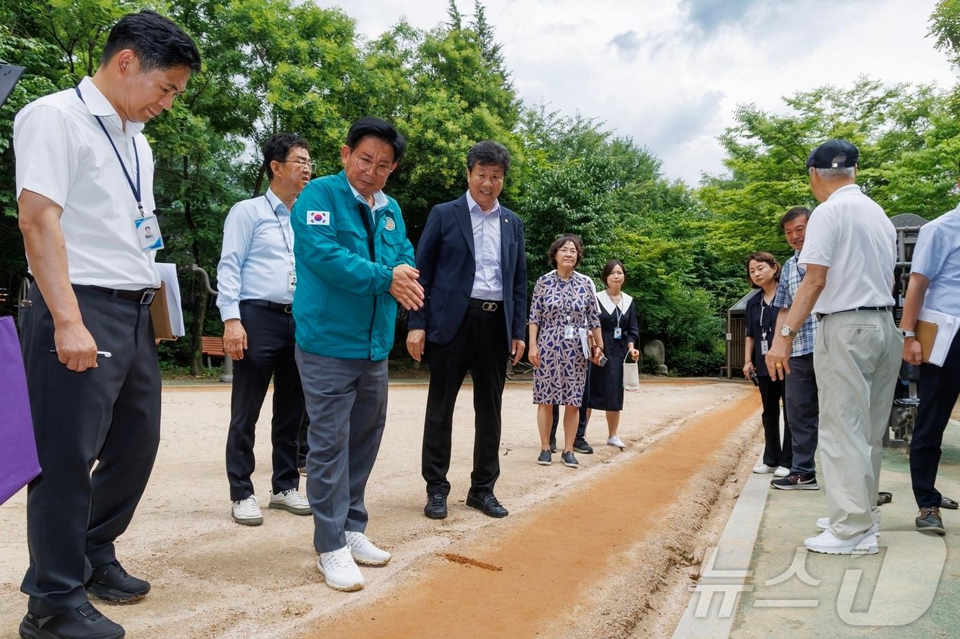 본문 이미지 - 지난달 도화동마을쉼터에 방문해 황톳길을 살피고 있는 박강수 마포구청장.(마포구청 제공)