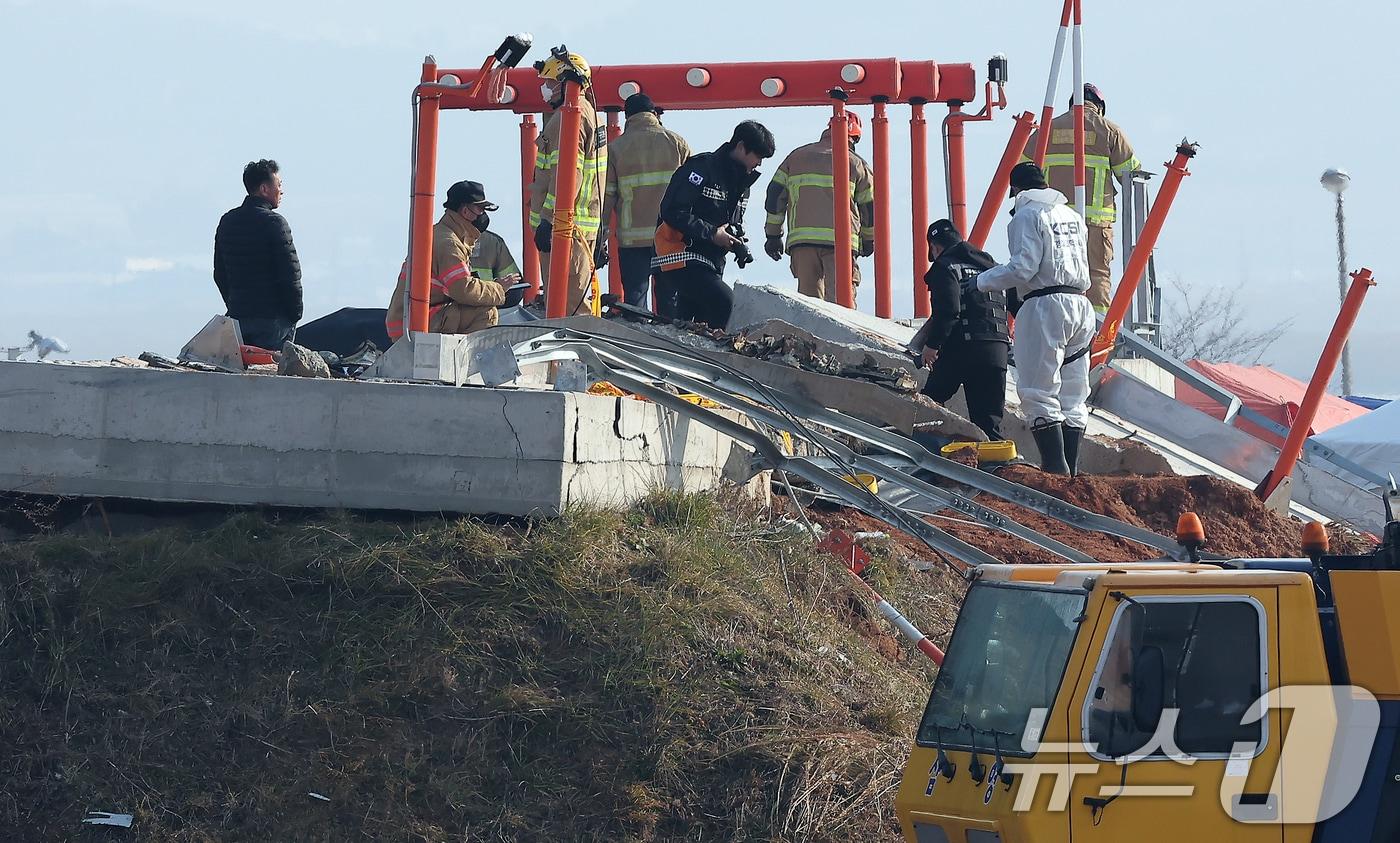 2일 전남 무안국제공항 제주항공 여객기 참사 현장에서 과학수사대와 119소방대원들이 방위각 시설(로컬라이저)를 살펴보고 있다. 2025.1.2/뉴스1 ⓒ News1 김진환 기자