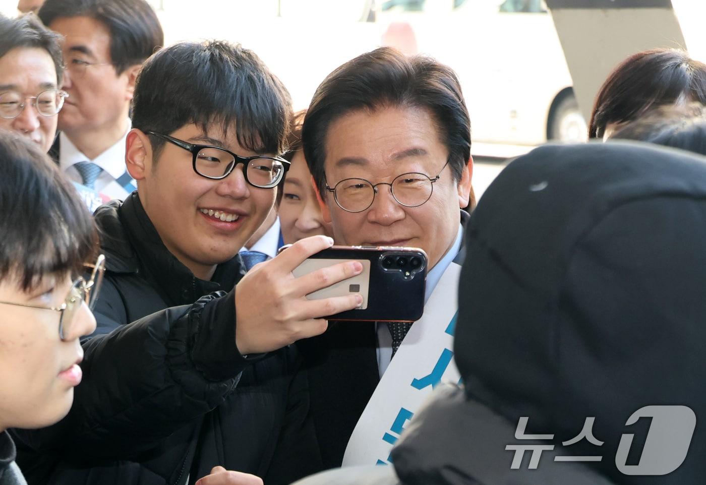 본문 이미지 - 이재명 더불어민주당 대표가 설 연휴를 앞둔 24일 오전 서울 서초구 반포동 고속버스터미널에서 설 귀성객에게 인사하던 중 사진을 찍고 있다. (공동취재) 2025.1.24/뉴스1 ⓒ News1 이동해 기자