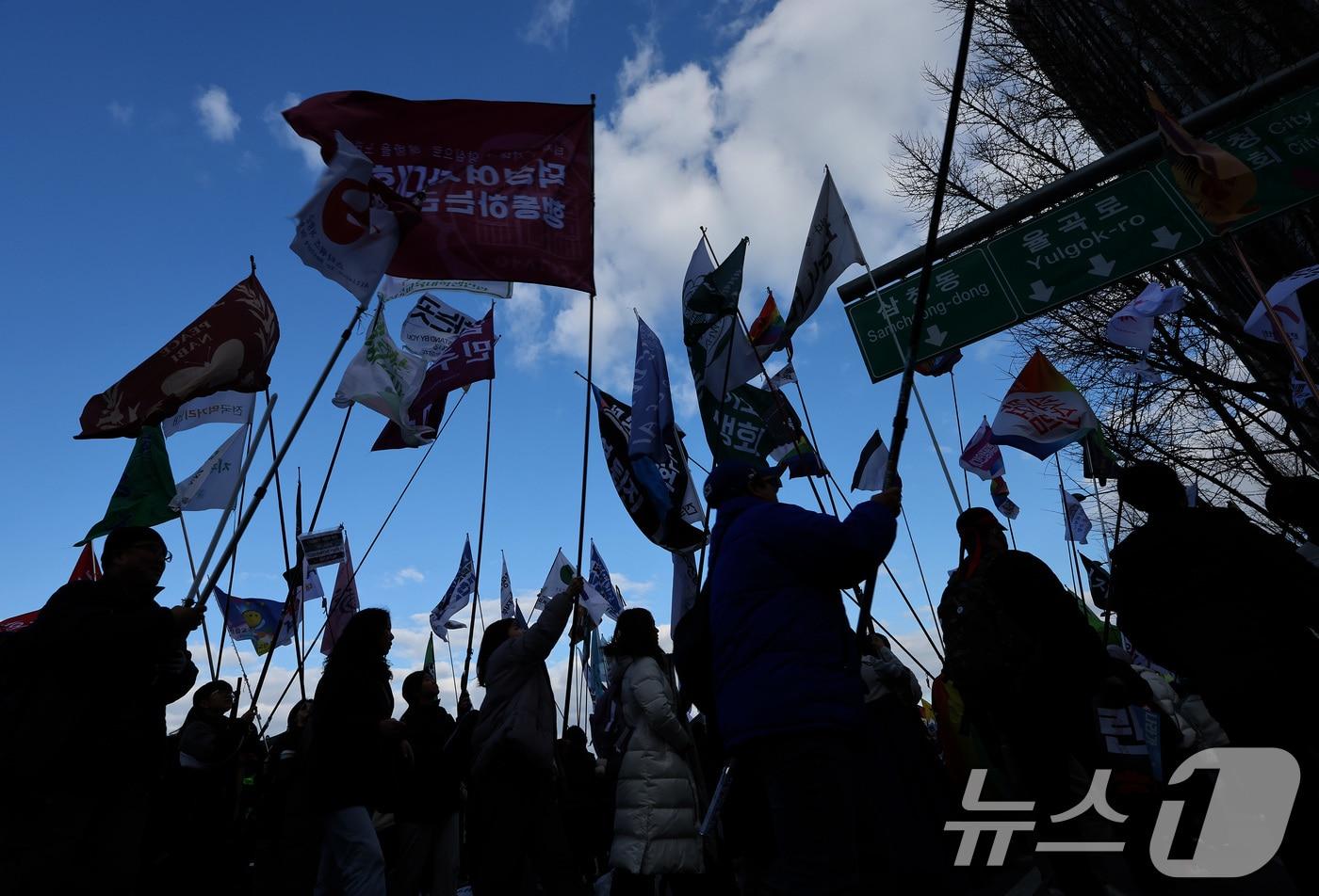 25일 오후 서울 종로구 경복궁역 일대에서 열린 윤석열 대통령 탄핵 촉구 집회에서 참석자들이 윤 대통령의 파면 등을 촉구하며 깃발 입장 퍼레이드를 하고 있다. 2025.1.25/뉴스1 ⓒ News1 이동해 기자