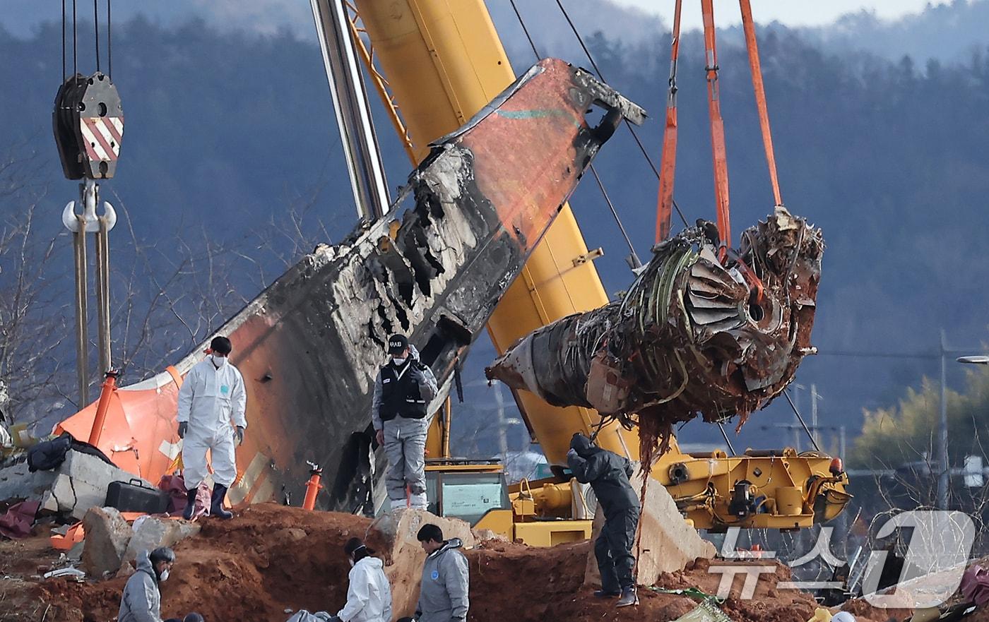 4일 오후 전남 무안국제공항 참사 현장에서 로컬라이저(방위각시설) 둔덕에 파묻힌 제주항공 7C2216편의 엔진이 크레인으로 옮겨지는 모습. ⓒ News1 김진환 기자