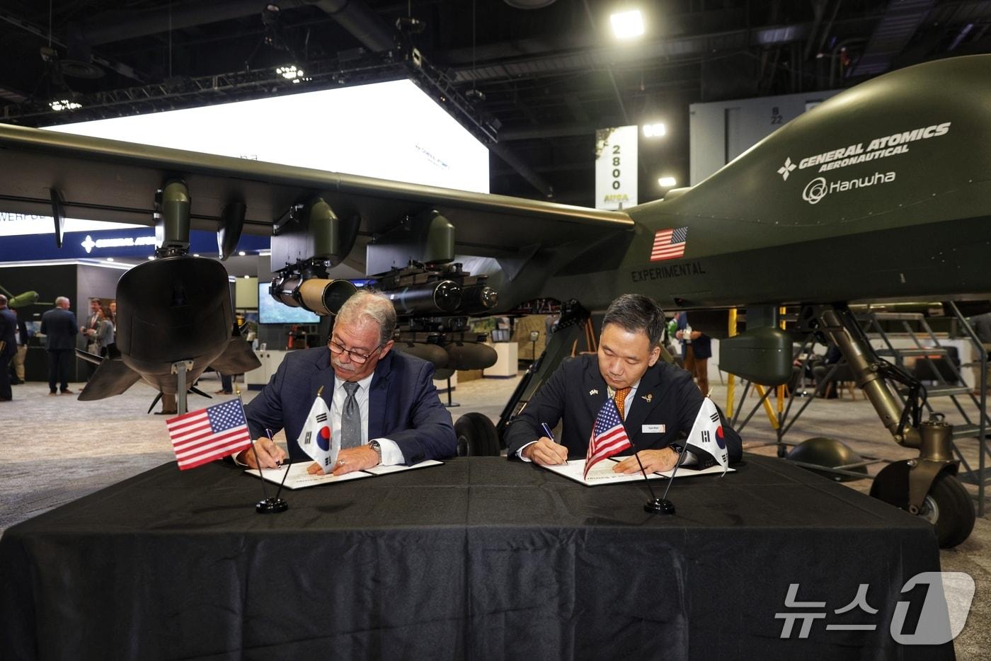 김선 한화에어로스페이스 항공사업부장 부사장&#40;오른쪽&#41;과 데이비드 알렉산더 제너럴 아토믹스 에어로노티컬 시스템즈 사장이 14일&#40;현지시간&#41; 미국 워싱턴DC에서 열린 AUSA 전시회에서 &#39;그레이 이글 단거리이착륙&#40;GE-STOL&#41; 무인기 공동개발 및 생산 협력 계약&#39;에 서명하고 있다&#40;한화에어로 제공&#41;