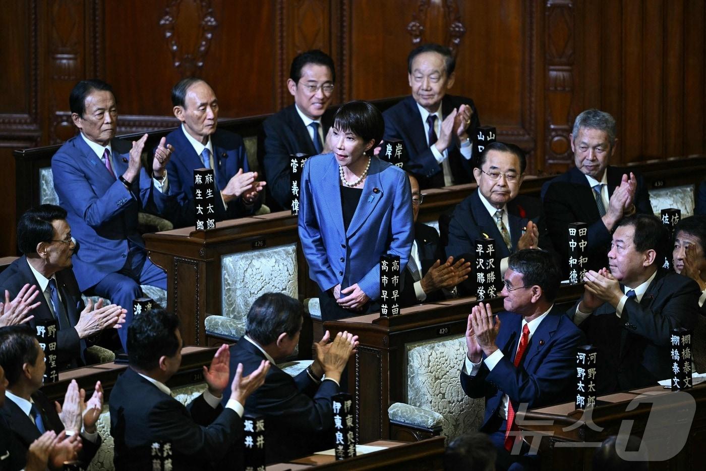 일본 집권 여당 자민당의 다카이치 사나에 총재가 21일 임시 국회에서 진행된 중의원 1차 총리 지명 투표에서 과반 득표로 총리로 지명되자 자리에서 일어나 인사하고 있다. 2025.10.21 ⓒ AFP=뉴스1 ⓒ News1 최종일 선임기자