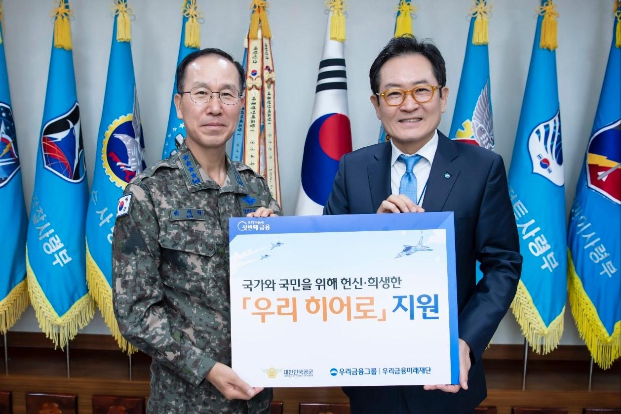 본문 이미지 - &#40;왼쪽부터&#41; 손석락 공군 참모총장과 장광익 우리금융미래재단 사무국장이 지난 28일 계룡대에서 공군에게 지원금을 전달하고 기념촬영을 했다. &#40;우리금융그룹 제공&#41;