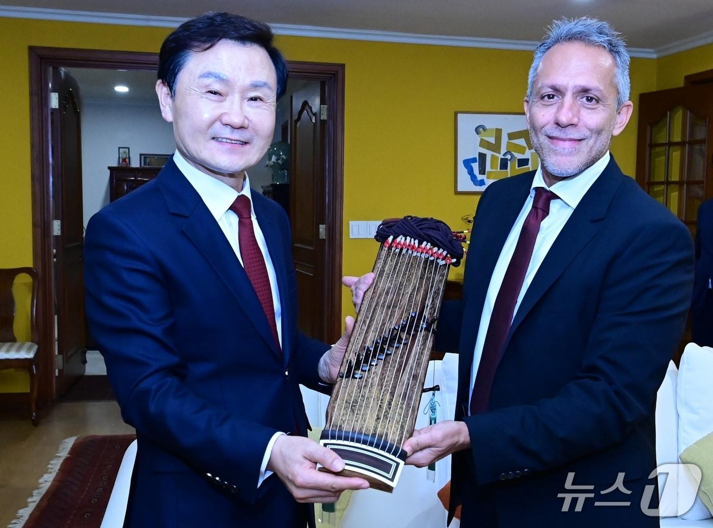 본문 이미지 - 이남철 고령군수(왼쪽)가 지난 30일 이탈리아 대사관저에서 안드레아 비르질리오 크레모나 시장에게 가야금을 선물하고 있다. (고령군 제공. 재판매 및 DB금지)/뉴스1