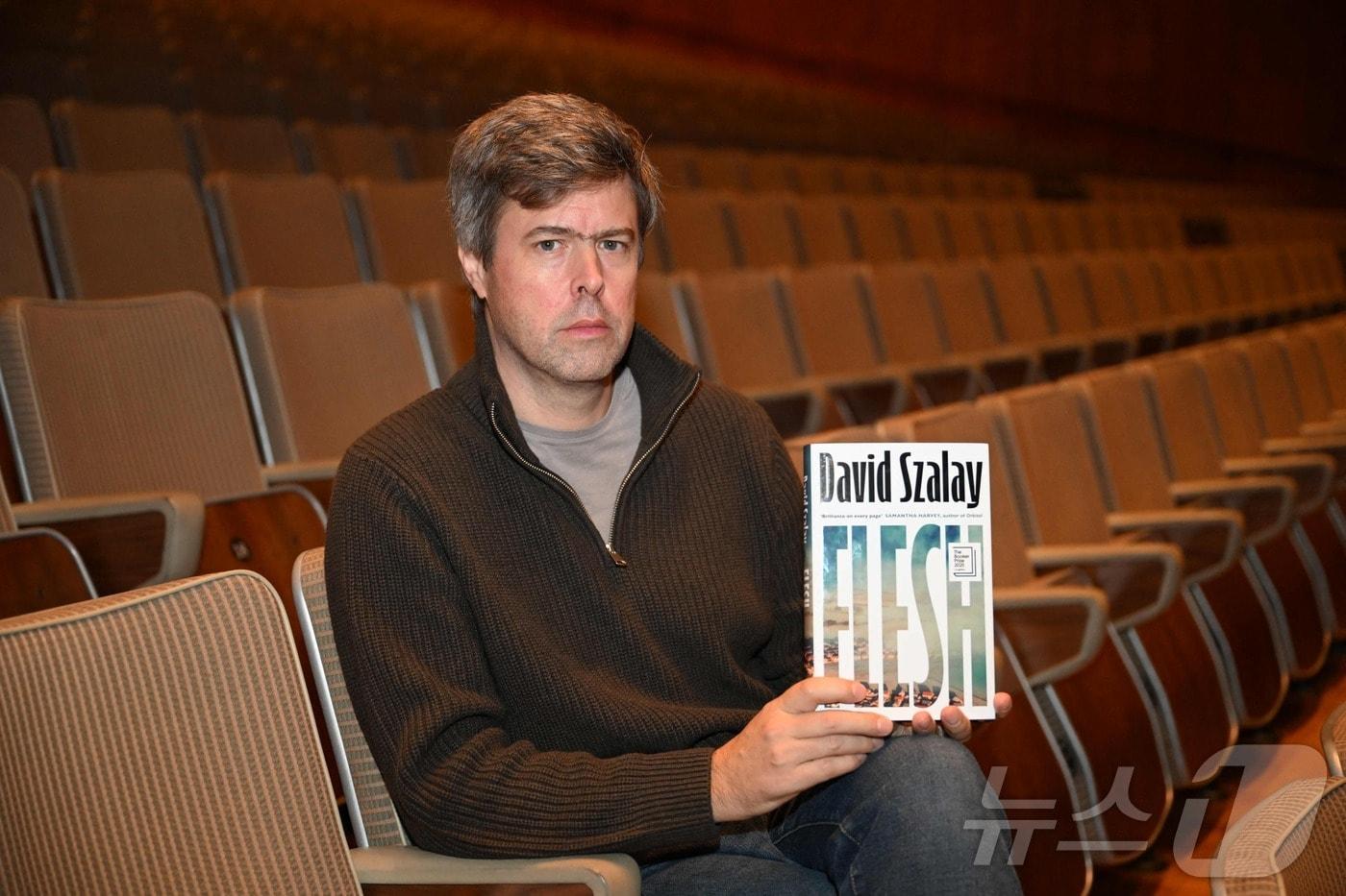 9일(현지시간) 헝가리계 영국 작가 데이비드 솔로이가 2025년 부커상 최종 후보 발표 전날 런던에서 열린 포토콜 행사에서 자신의 소설 '플레시'(Flesh)를 들고 포즈를 취하고 있다. 2025. 11. 09. ⓒ AFP=뉴스1 ⓒ News1 양은하 기자