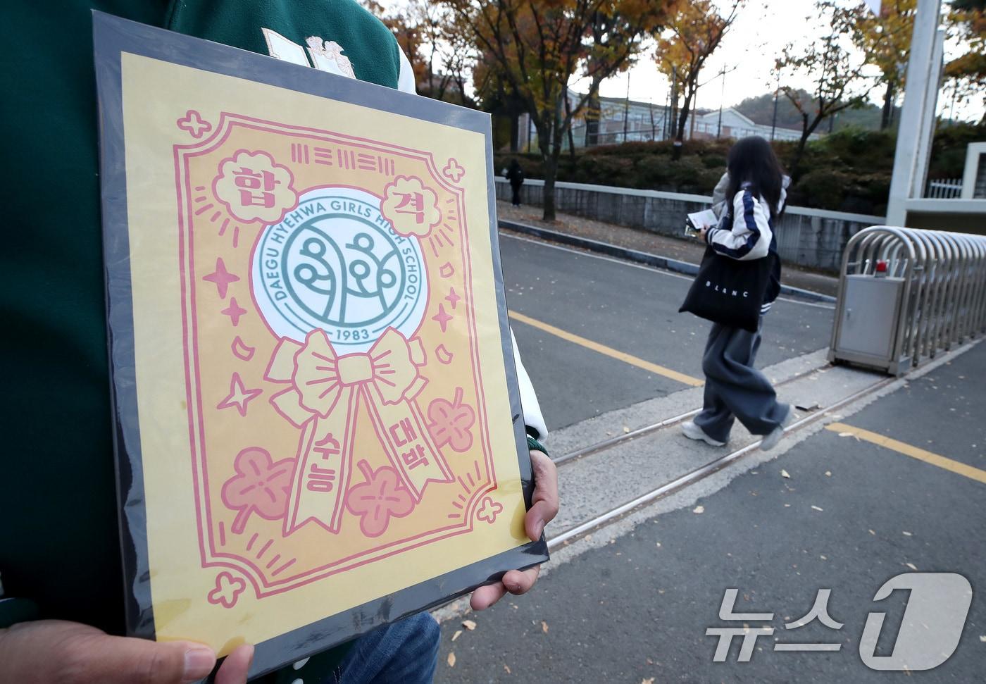 2026학년도 대학수학능력시험일인 13일 오전 대구 수성구 정화여고에 마련된 시험장 앞에서 한 교사가 부적을 손에 들고 출신학교 수험생을 응원하고 있다. &#40;사진은 기사 내용과 무관함&#41; 2025.11.13/뉴스1 ⓒ News1 공정식 기자