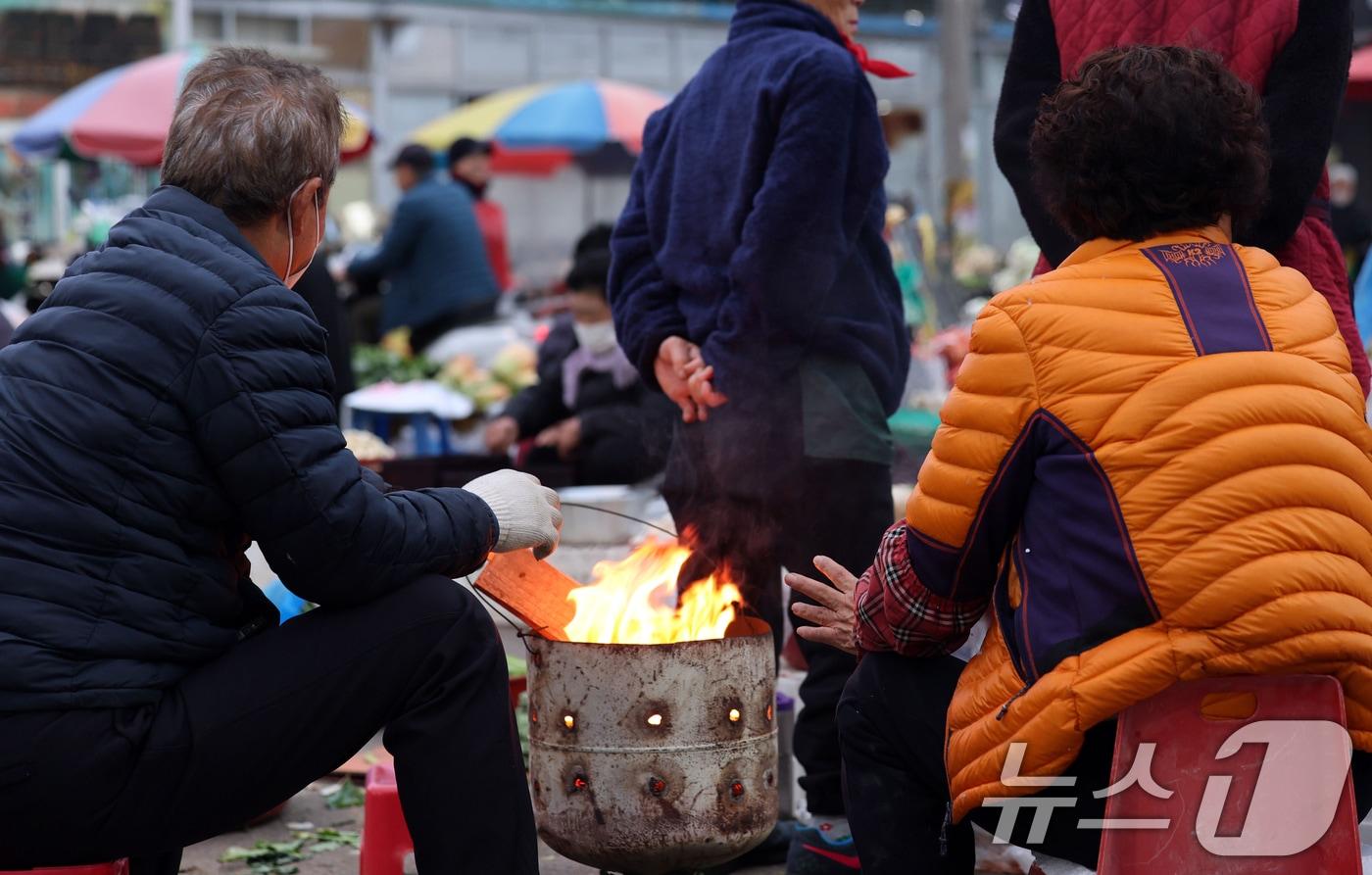 광주 무등산 아침최저기온이 -3.3도를 기록한 18일 오전 광주 동구 남광주시장 상인들이 추위를 피하기 위해 불을 쬐고 있다. 2025.11.18/뉴스1 ⓒ News1 박지현 기자