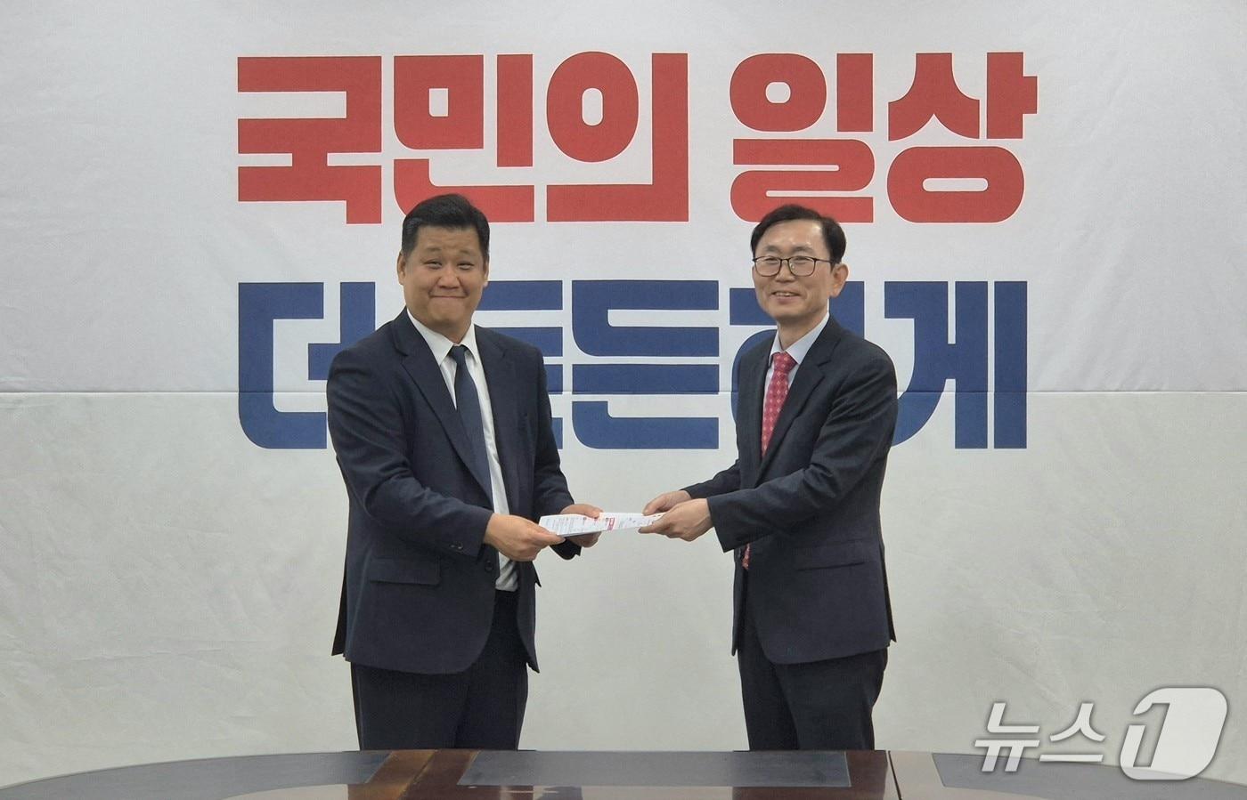 권오상 전 대구시 환경수자원국장(오른쪽)이 18일 국민의힘 대구시당에서 홍창훈 대구시당 사무처장에게 입당 서류를 전달하고 있다. (권오상 전 대구시 환경수자원국장 측 제공. 재판매 및 DB 금지) 2025.11.18/뉴스1