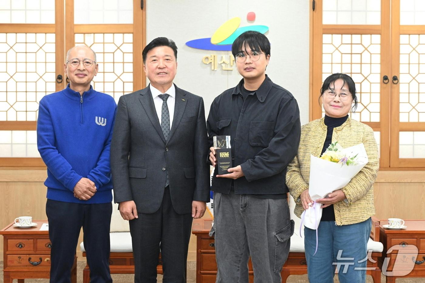 최재구 예산군수와 기념촬영하는 김봉섭 작곡가. (예산군 제공. 재판매 및 DB금지) 2025.11.20/뉴스1