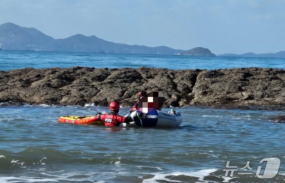 본문 이미지 - 격포해수욕장에서 갯바위에 올라 바다를 감상하던 50대가 해경에 의해 구조되고 있다.(부안해경 제공. 재판매 및 DB금지)