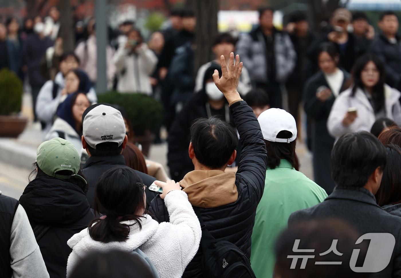 서울캠퍼스에서 한 학부모가 2026학년도 수시 모집 논술전형 논술고사를 마친 자녀에게 손을 들어보이고 있다. /뉴스1 ⓒ News1 김민지 기자