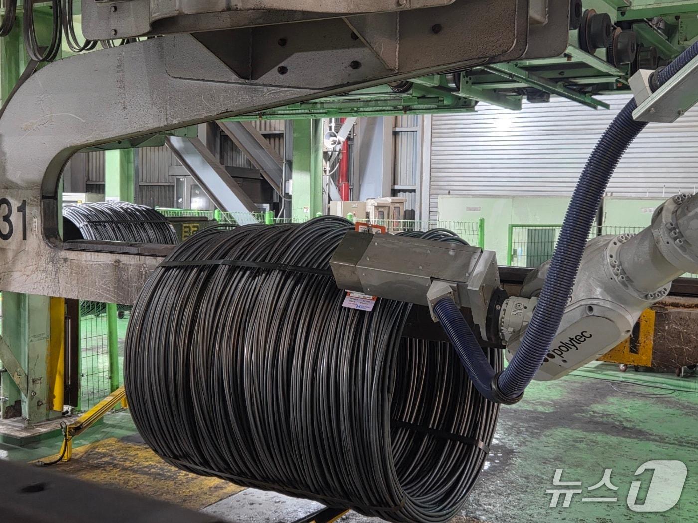 본문 이미지 - 현대제철 '선재 태깅 로봇'이 제품에 태그를 부착하는 모습(현대제철 제공)