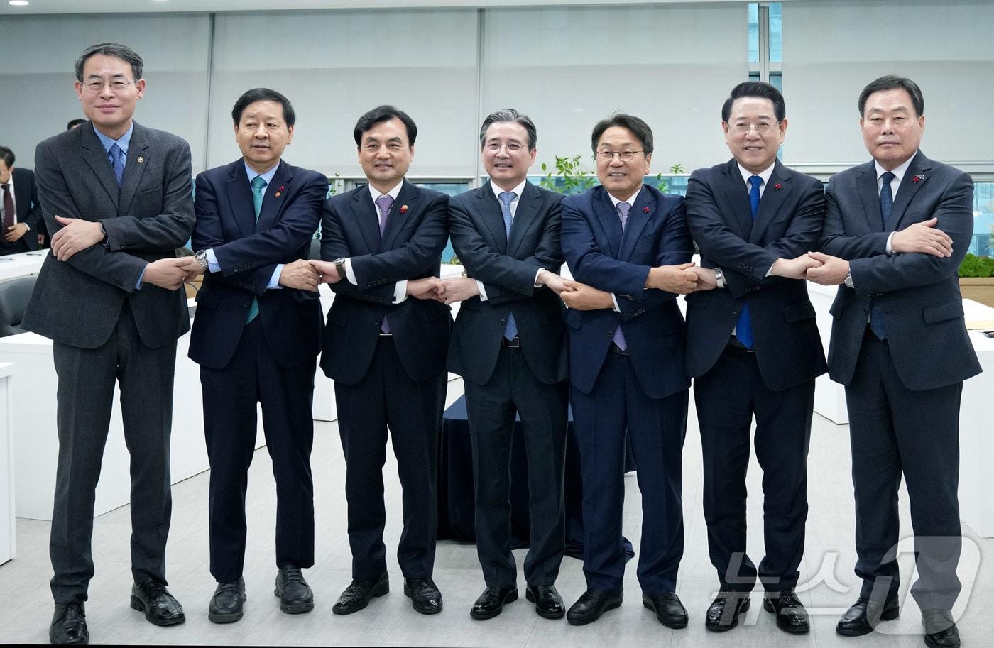 김영록 전라남도지사가 17일 광주에서 열린 ‘광주 군 공항 이전 6자 협의체’회의에서 대통령실 김용범 정책실장, 구윤철 기획재정부장관, 안규백 국방부장관, 강희업 국토교통부2차관, 강기정 광주시장, 김산 무안군수 등과 기념촬영을 하고 있다.(전남도 제공. 재판매 및 DB금지) 2025.12.17/뉴스1