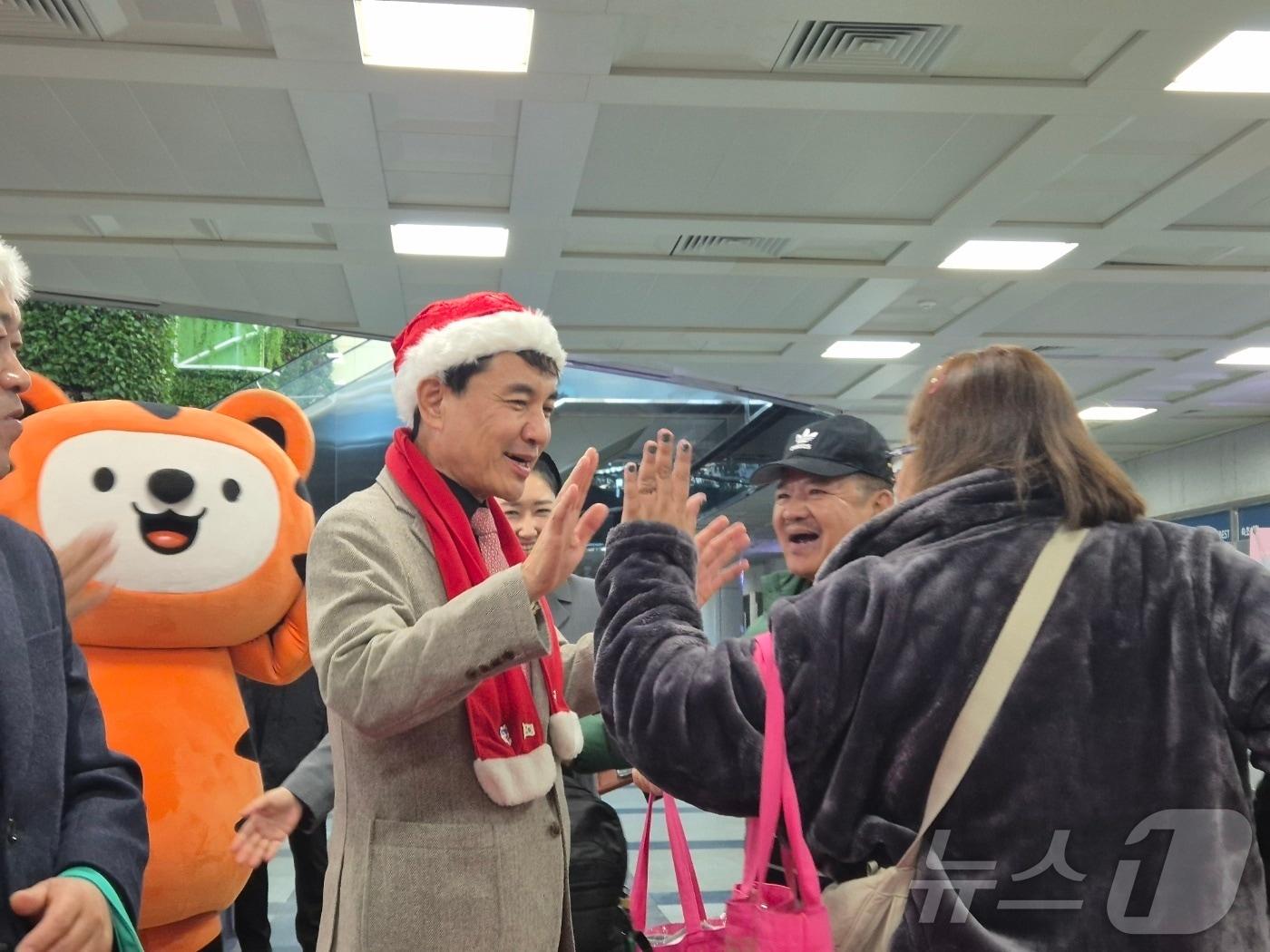 본문 이미지 - 18일 강원 양양국제공항 입국장에서 김진태 강원도지사가 산타 복장을 한 채 필리핀 단체 관광객을 환영하고 있다. 이날 필리핀 마닐라에서 도착한 관광객 173명은 '동계시즌 양양~필리핀 전세기' 운항을 통해 입국한 1차 단체팀으로, 강원도는 이들을 대상으로 꽃다발 증정, 기념품 전달, K-POP 공연 등 대규모 환영행사를 진행했다.2025.12.18/뉴스1 ⓒ News1 윤왕근 기자