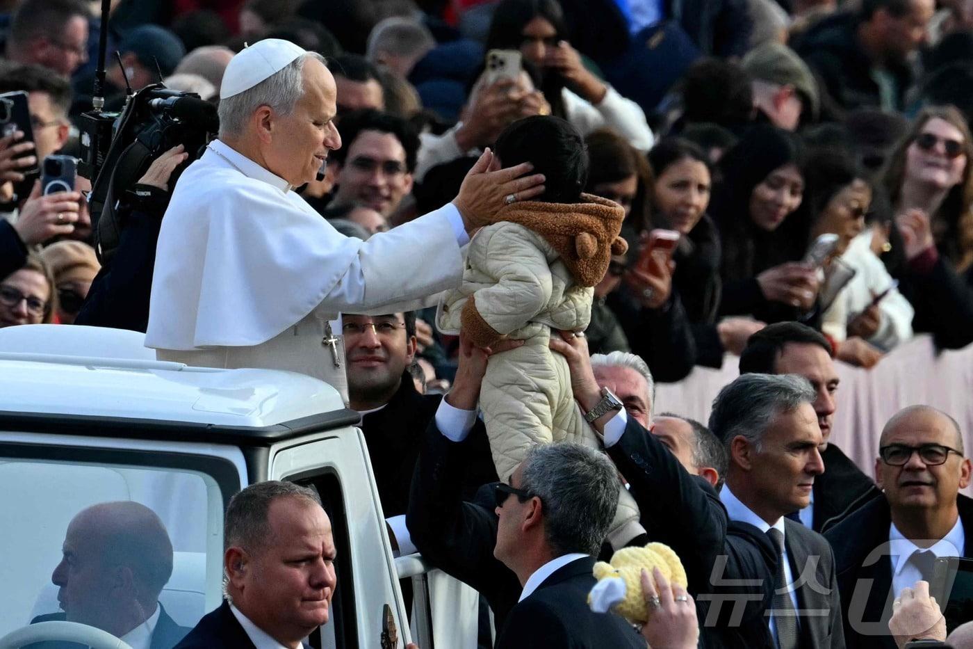 레오 14세 교황이 17일(현지시간) 바티칸 성 베드로 광장에서 한 어린이를 축복하고 있다. 2025.12.17. ⓒ AFP=뉴스1 ⓒ News1 윤다정 기자