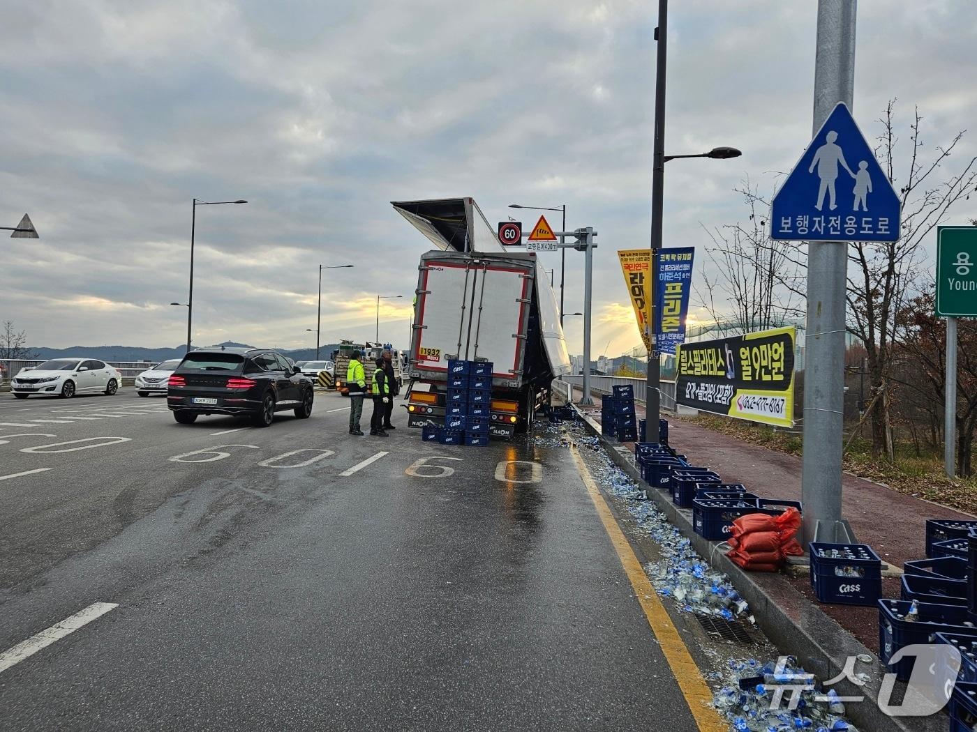 본문 이미지 - 19일 오전 7시 40분쯤 광주 북구 용두동 용두대교에서 주행하던 25톤 트럭에서 맥주상자가 쏟아진 모습.(독자 제공. 재판매 및 DB 금지)