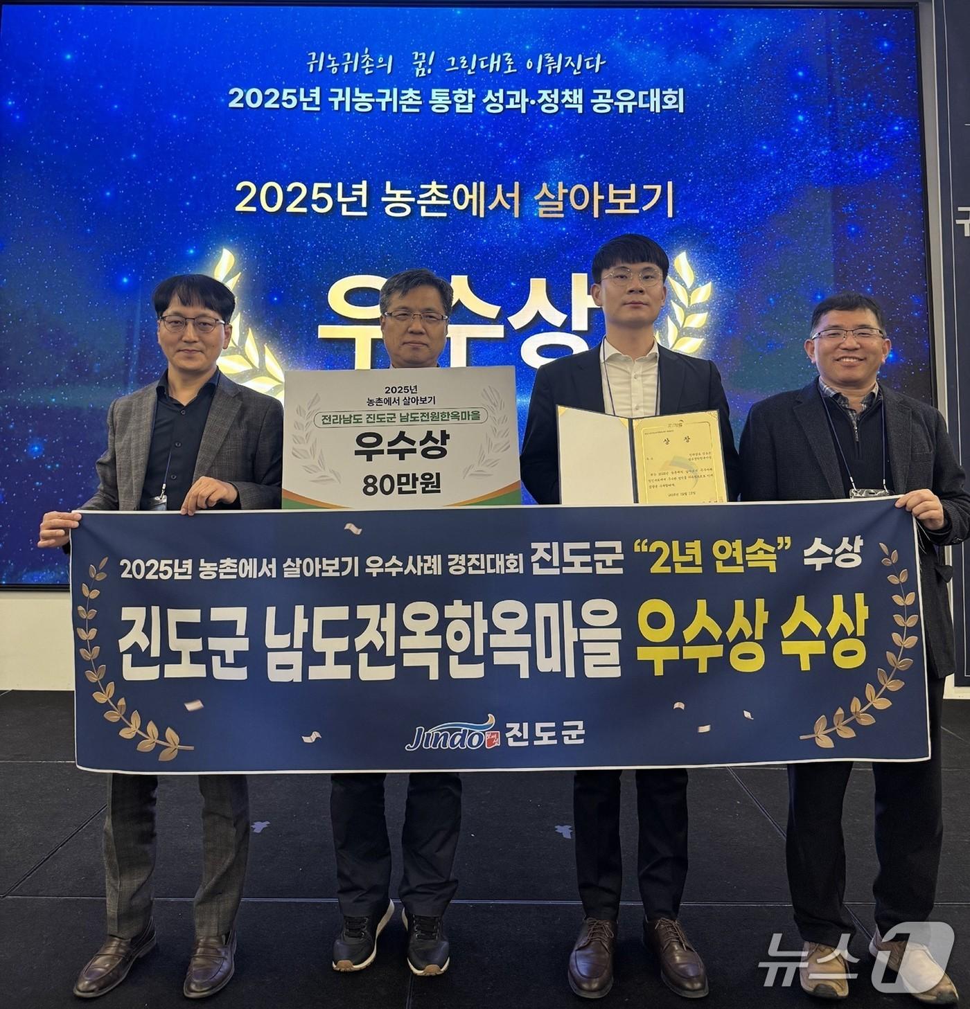 본문 이미지 - 남도전원한옥마을 관계자들이 '2025년 농촌에서 살아보기 우수사례 경진대회'우수상을 수상한 뒤 기념사진을 찍고 있다.(진도군 제공, 재판매 및 DB금지)/뉴스1