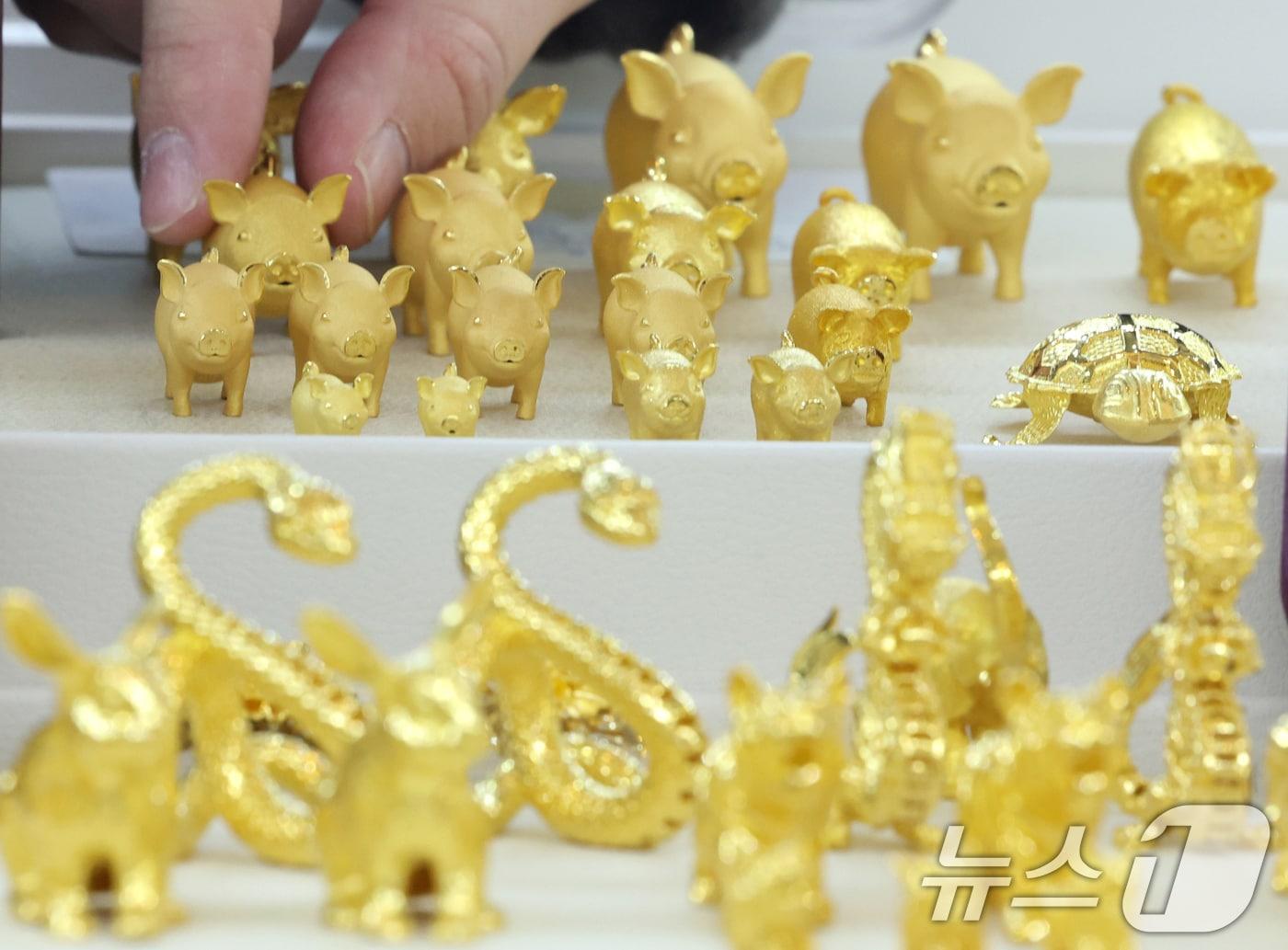 본문 이미지 - 미국과 베네수엘라 간의 군사적 긴장이 최고조에 달하면서 국제 금값이 사상 최고치를 갈아치웠다. 23일(한국시간) 국제 금 현물 가격은 전 거래일 대비 2.2% 급등한 온스당 4434.26달러를 기록했다. 장중 한때 4441.92달러까지 치솟으며 역대 최고치를 갈아 치웠다. 금값은 올해 초와 비교하면 69% 이상 상승해 제2차 오일쇼크가 있었던 1979년 이후 최대 연간 상승 폭을 기록 중이다. 사진은 서울 종로구 한국금거래소에서 관계자가 금을 진열하는 모습. 2025.12.23/뉴스1 ⓒ News1 황기선 기자