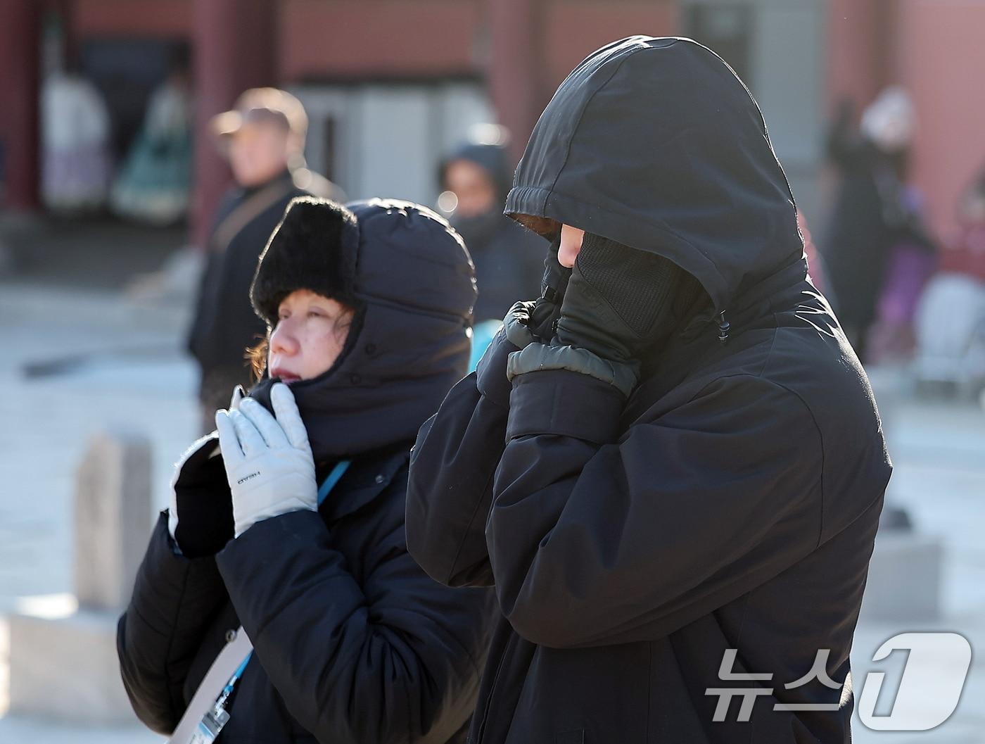 본문 이미지 - 서울과 경기에 한파주의보가 내려진 25일 서울 종로구 경복궁을 찾은 외국인 관광객들이 강추위에 목도리 등 방한용품을 두른채 이동하고 있다. 2025.12.25/뉴스1 ⓒ News1 김진환 기자