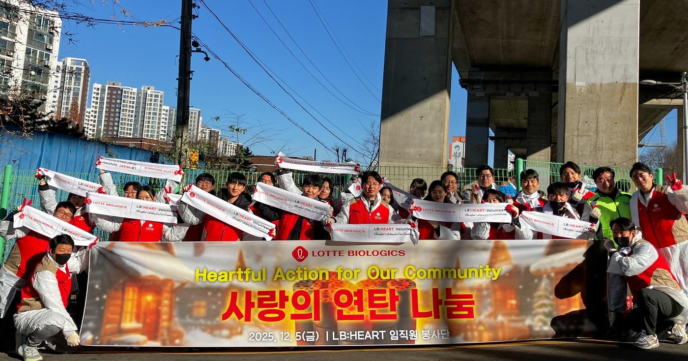 롯데바이오로직스 임직원들이 사랑의 연탄 나눔 행사에 참여해 기념촬영을 하고 있다. /제공 = 롯데바이오로직스