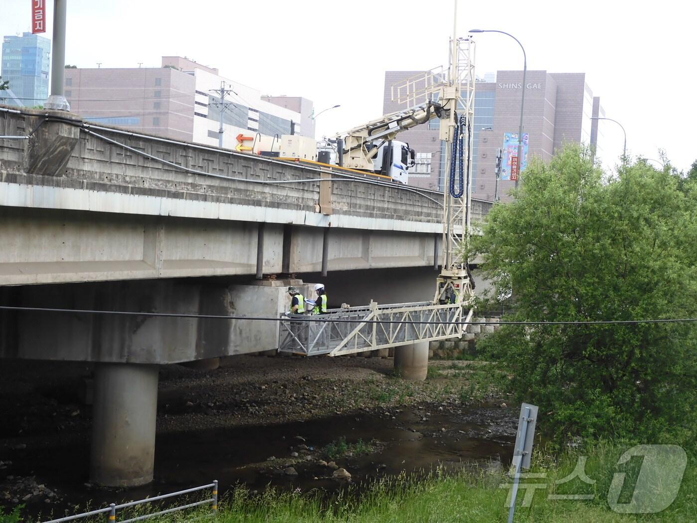 본문 이미지 - 용인시의 한 교량에서 관계자들이 안전점검을 하고 있는 모습.&#40;용인시 제공&#41;