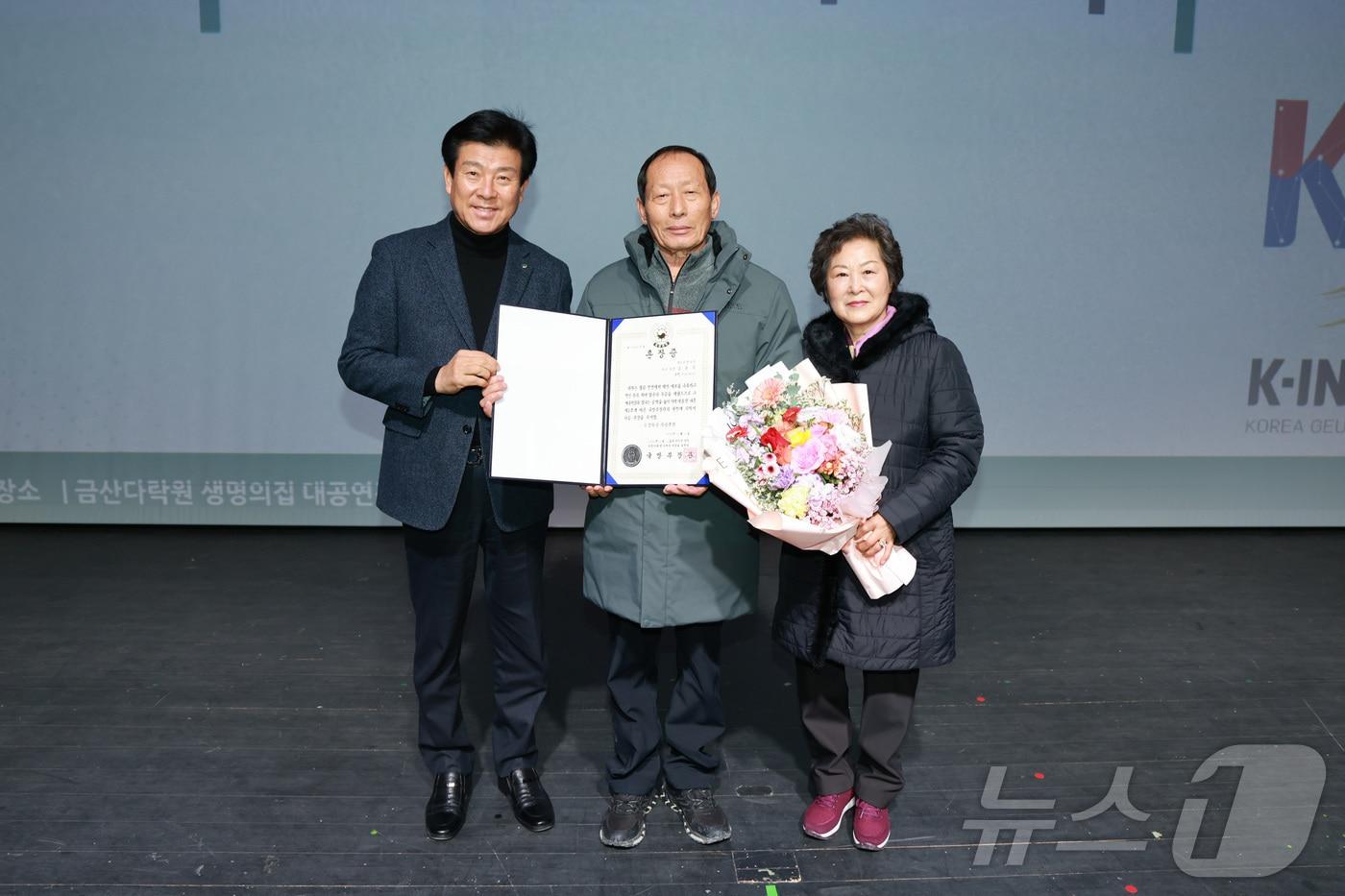 금산 다락원에서 열린 고 김영식 병장 화랑무공훈장 전수식에서 박범인 군수(왼쪽)와 김 병장의 조카 김승겸 씨(가운데)가 기념사진을 찍고 있다. (금산군 제공) / 뉴스1