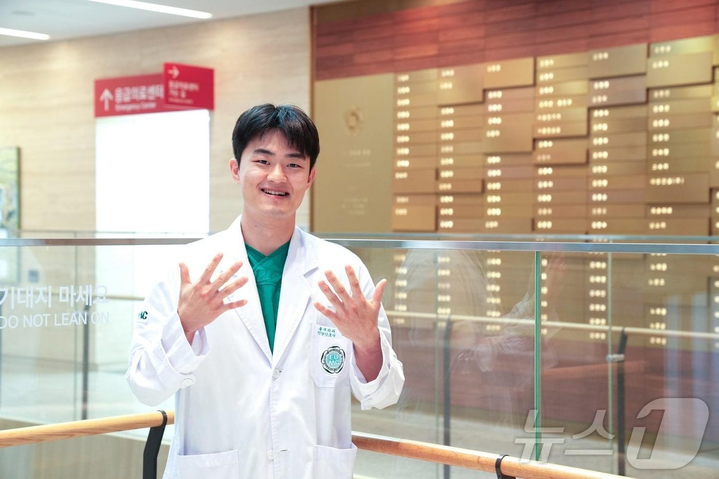 이대서울병원 양원준 간호사가 1층 로비에서 손을 들고 포즈를 취하고 있다.(이대서울병원 제공)