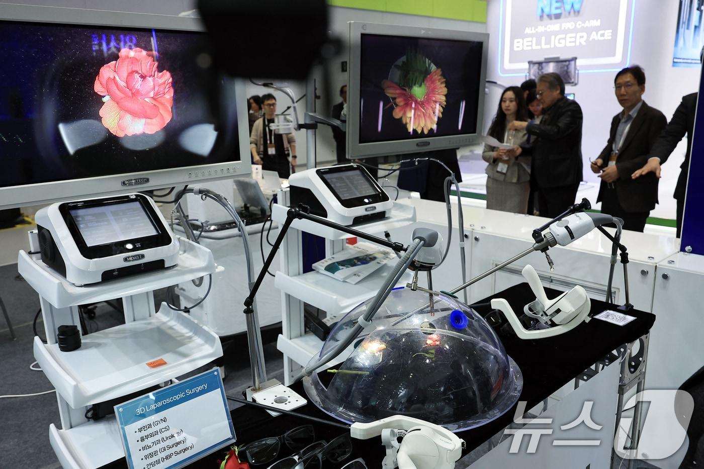 본문 이미지 - 20일 오후 서울 강남구 삼성동 코엑스에서 열린 제40회 국제의료기기·병원설비전시회(KIMES 2025)를 찾은 참관객들이 썸텍 부스에서 3D 복강경 수술 장비 등을 살펴보고 있다. 2025.3.20/뉴스1 ⓒ News1 박정호 기자