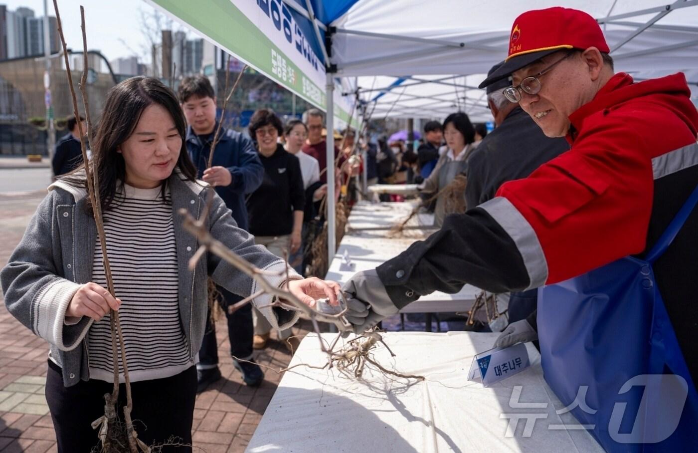 충북 증평군은 26일 증평군립도서관 앞에서 '내 나무 갖기 캠페인'을 열고 군민에게 유실수 묘목 1800그루를 무료로 나눠줬다.(증평군 제공, 재판매 및 DB금지)/뉴스1