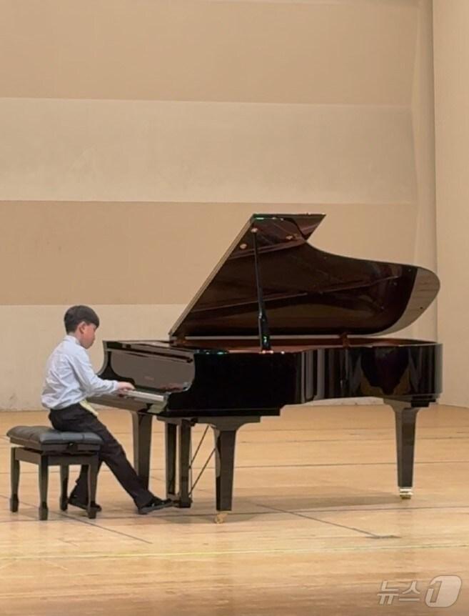 본문 이미지 -  전체 1등상을 수상한 한율초교 2학년 이재현 학생이 피아노를 연주하고 있다. (경기도영재음악교류협회 제공)  