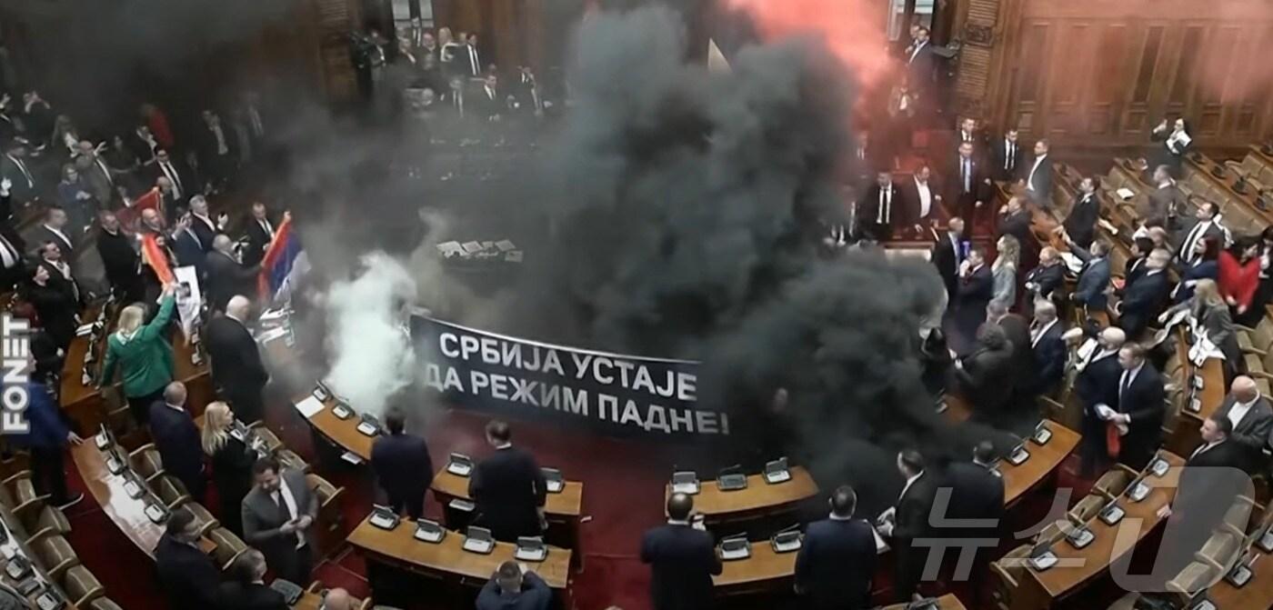 4일(현지시간) 세르비아 베오그라드시의 의회 의사당에서 최루탄·조명탄이 날아들어 혼란스러운 모습. (Bloomberg Televison 유튜브 갈무리)
