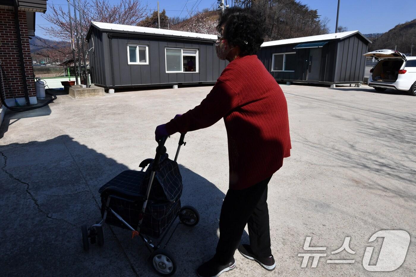 7일 오전 산불피해 지역인 경북 영덕군 지품면 황장 3리 마을회관 앞에서 이재민들이 공동으로 사용할 조립식 컨테이너를 바라보고 있다. 영덕군은 우선적으로 지품면에 조립식 컨테이너 주택 11동을 설치하고 순차적으로 이재민들에게 공급한다는 계획이다. 2025.4.7/뉴스1 ⓒ News1 최창호 기자