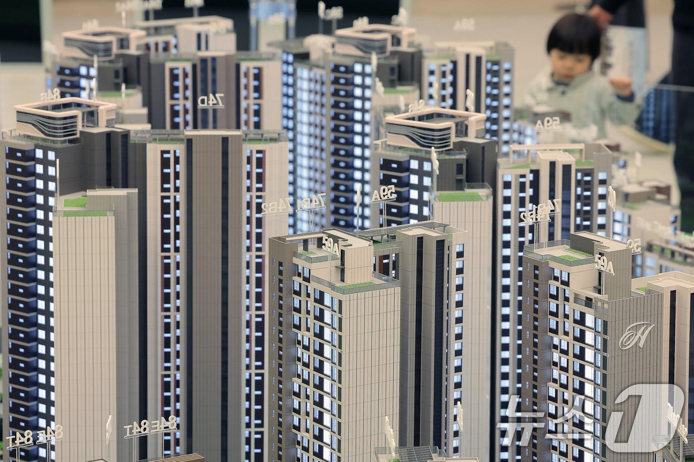 서울의 한 견본주택을 찾은 시민들이 단지배치 모형을 살펴보고 있다./뉴스1 ⓒ News1 박정호 기자