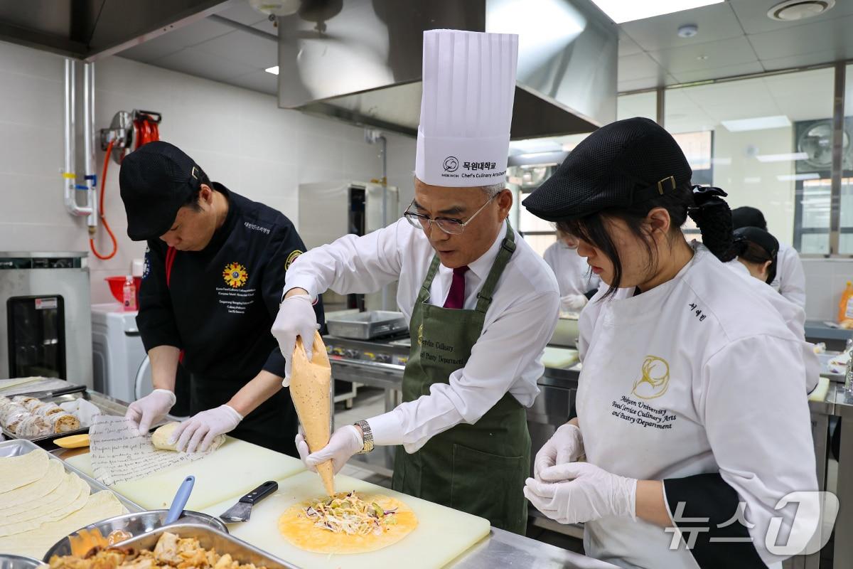 본문 이미지 - 이희학 총장(가운데)이 그릴드치킨롤 샌드위치를 만들고 있다.(목원대 제공.재판매 및 DB금지)/뉴스1