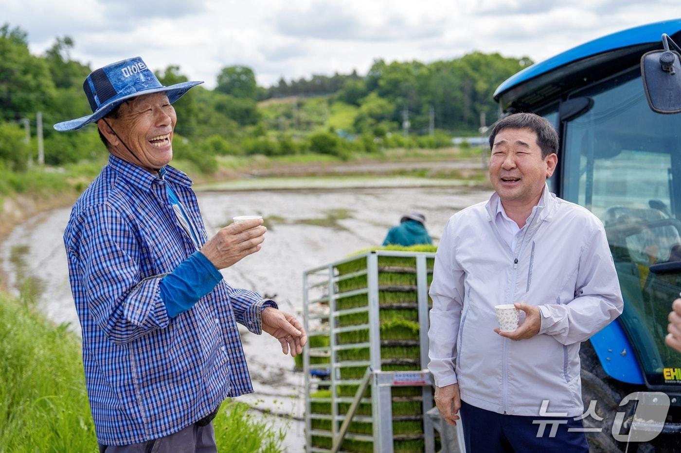 이재영 충북 증평군수(오른쪽)가 바쁜 농작업이 이어지는 일선 현장을 직접 찾아 농업인을 격려하며 환하게 웃고 있다.(증평군 제공)/뉴스1